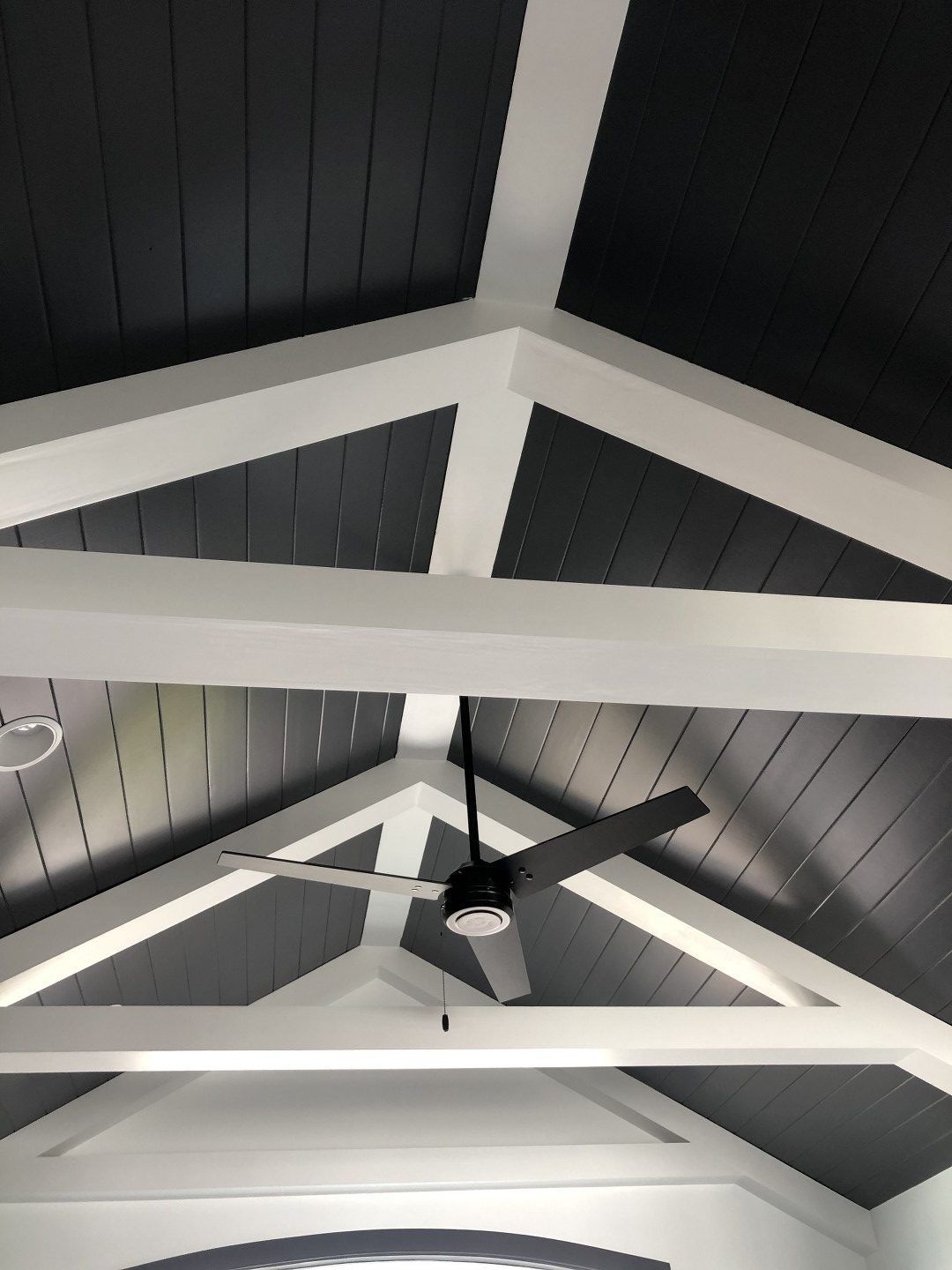 A ceiling fan is hanging from the ceiling of a building.