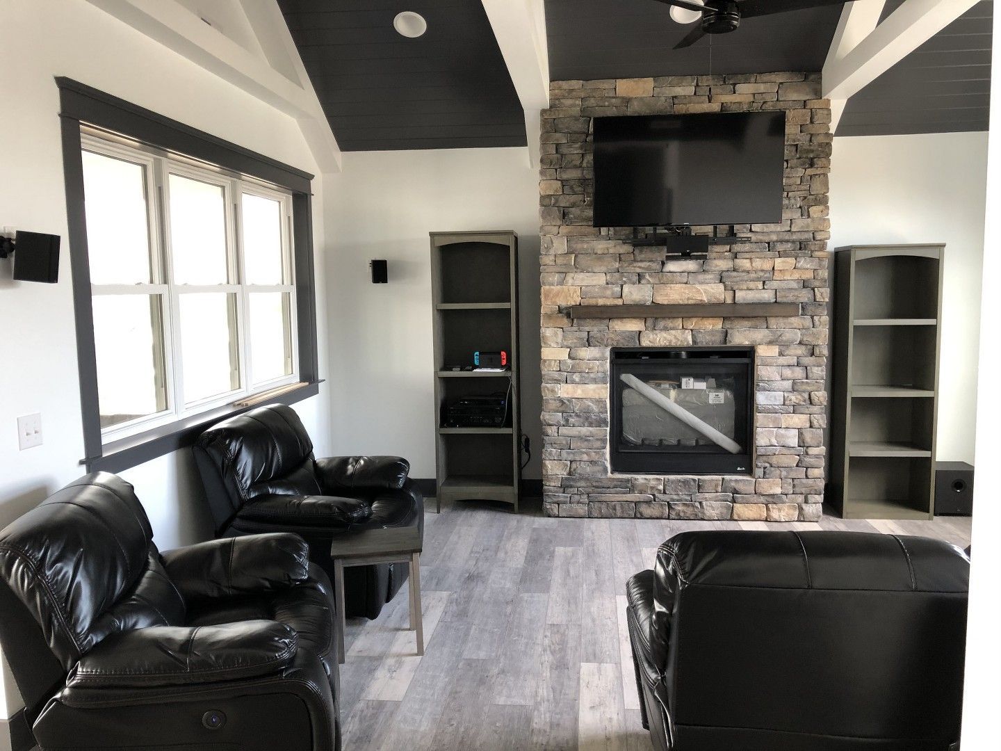 A living room with a fireplace and a flat screen tv