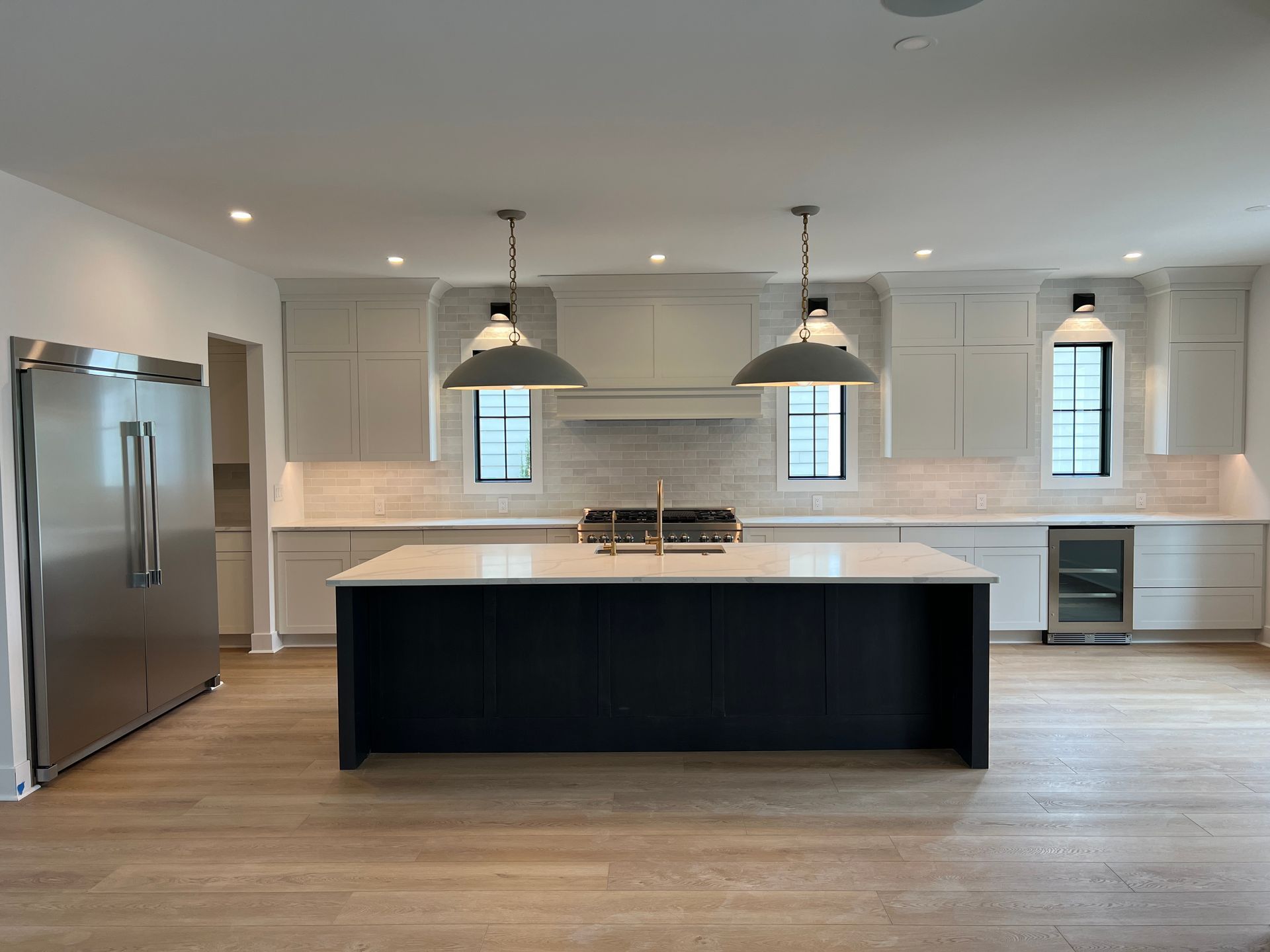 A kitchen with a large island and stainless steel appliances.