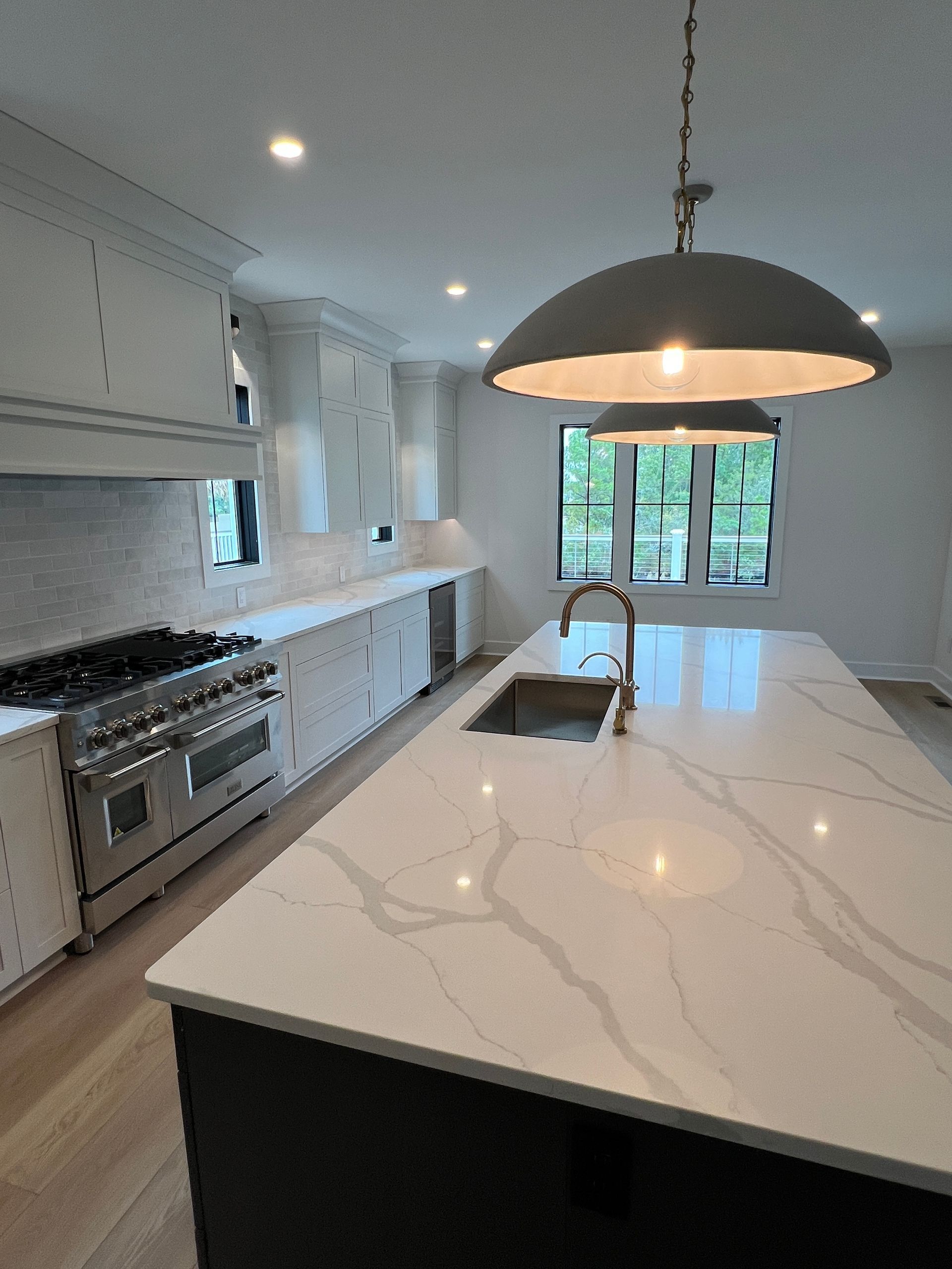A kitchen with a large island and a sink.