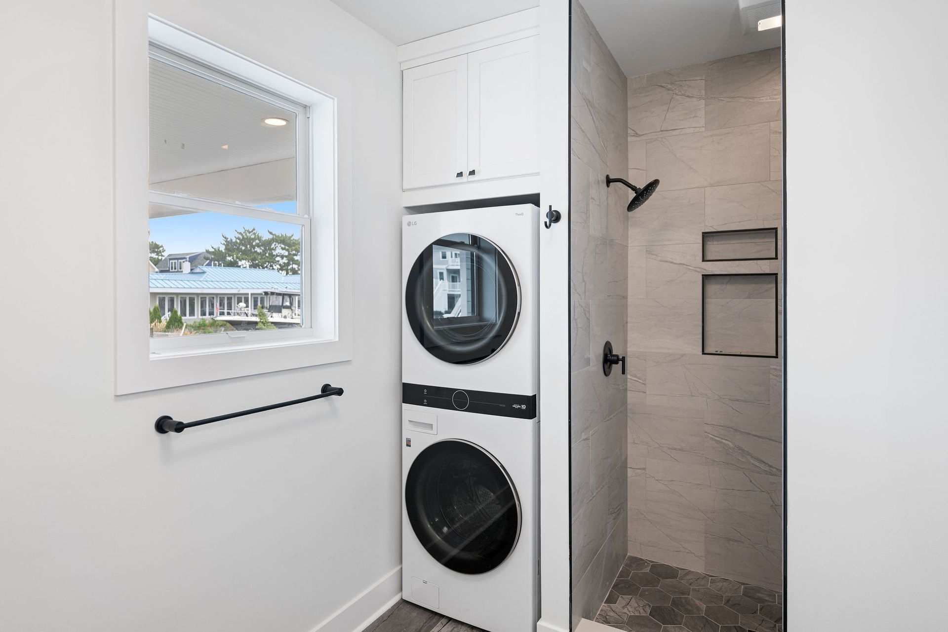 A laundry room with a washer and dryer stacked on top of each other.