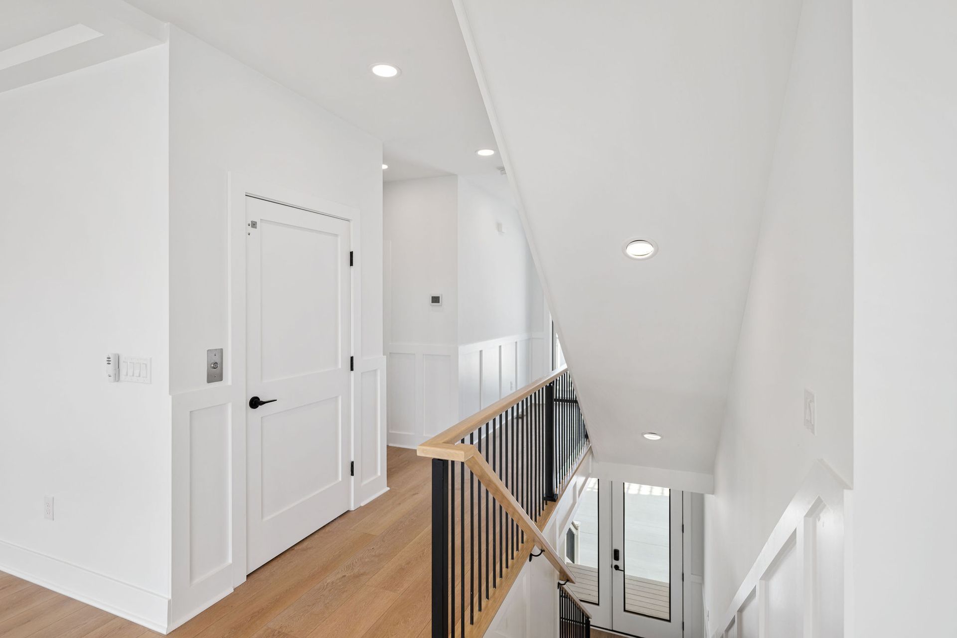 A hallway with stairs leading up to the second floor of a house.