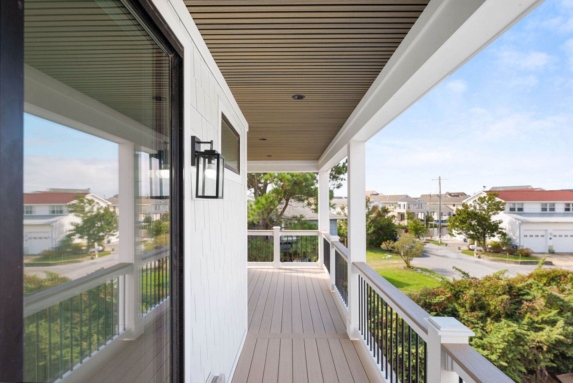 A balcony with a view of a residential area.