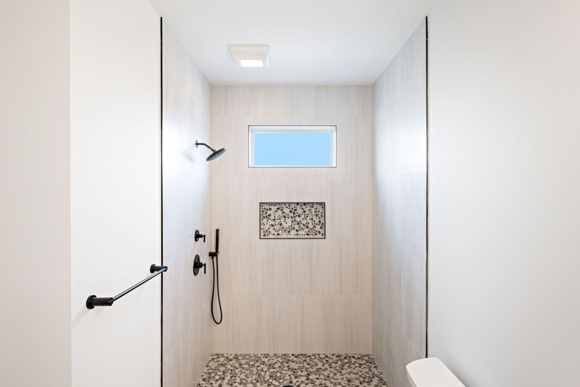 A bathroom with a walk in shower and a toilet.