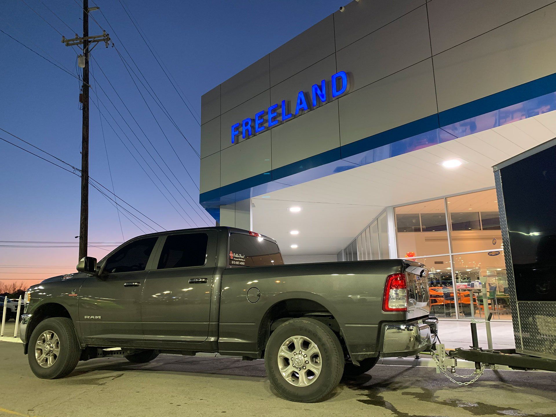 service truck parked in front of car dealership