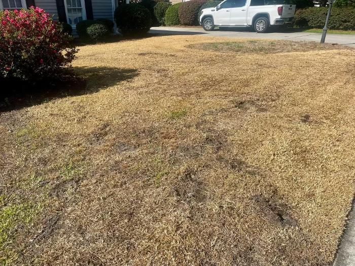 A white truck is parked in the driveway of a house.