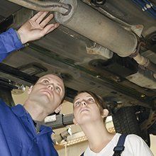 Man and woman showing auto parts