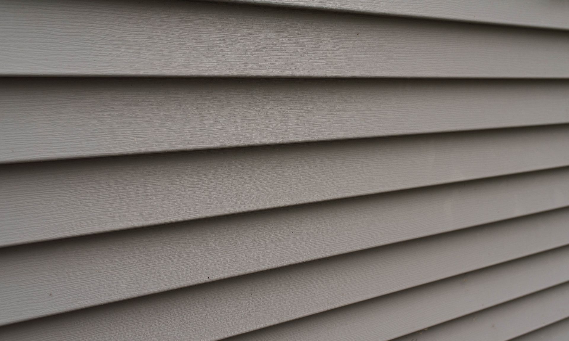 a close-up of a gray siding on a house.