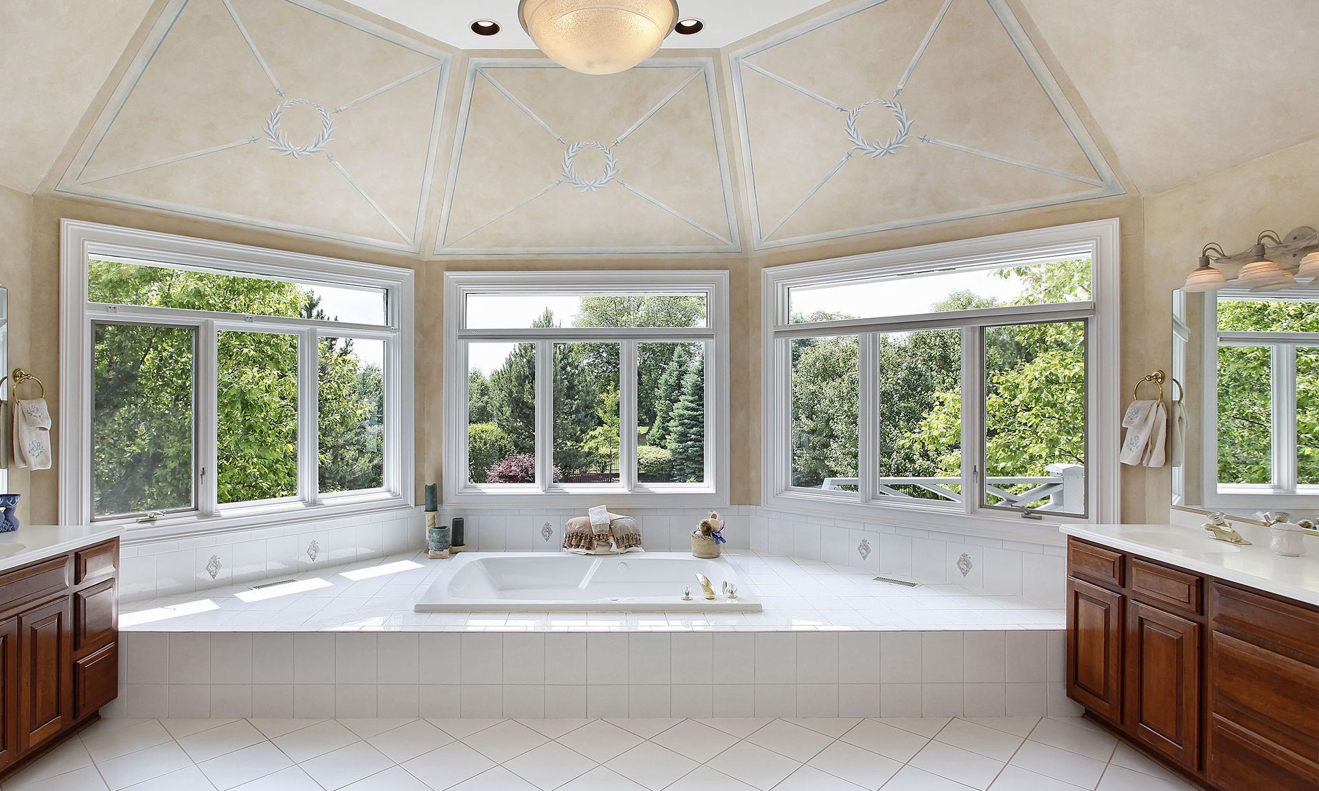 a bathroom with a large tub and lots of windows.