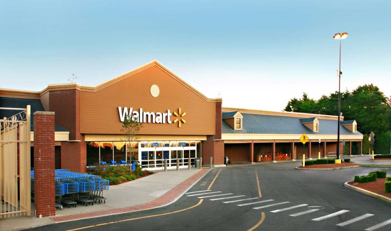 A Walmart store with a parking lot in front of it