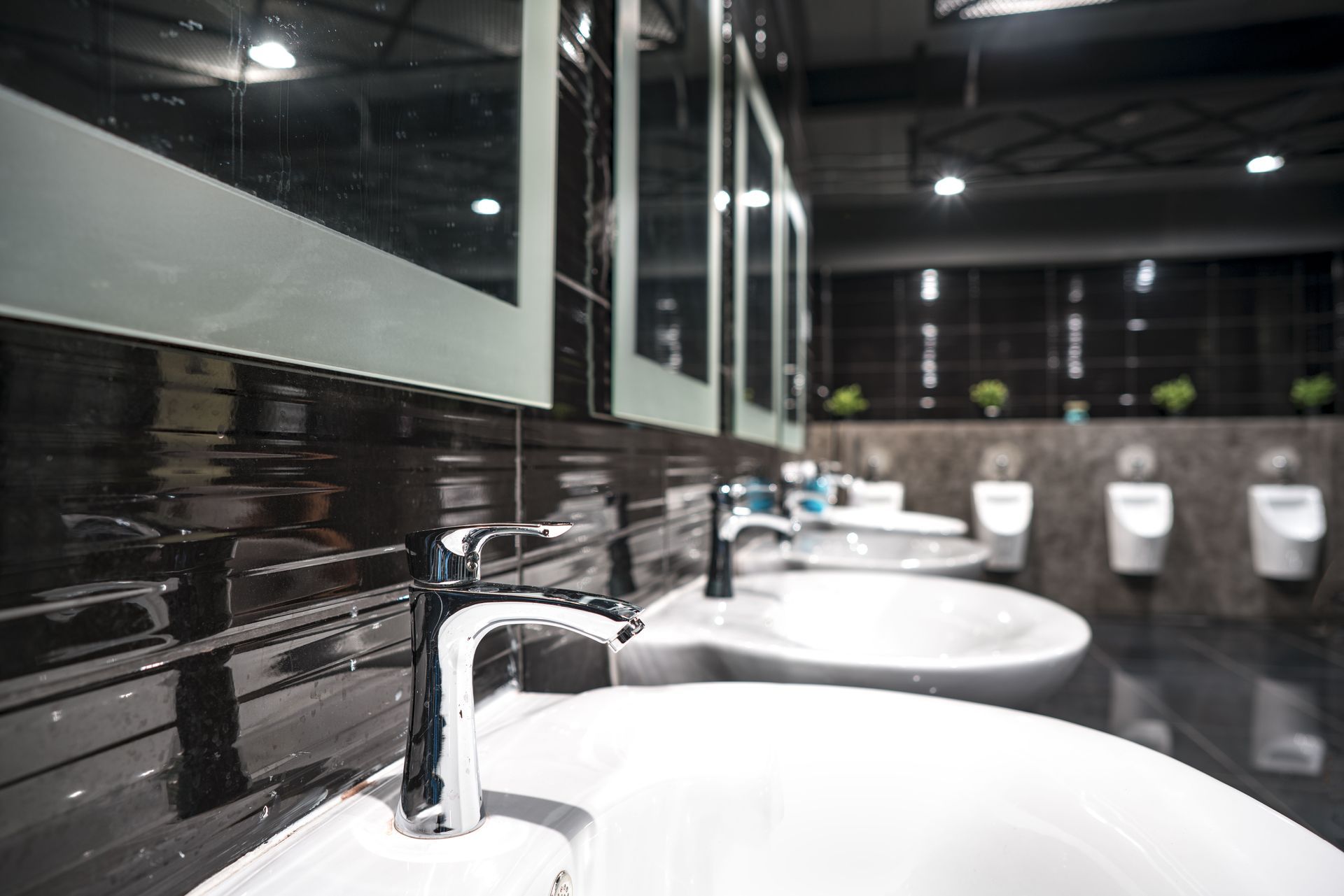 A row of sinks and urinals in a public restroom