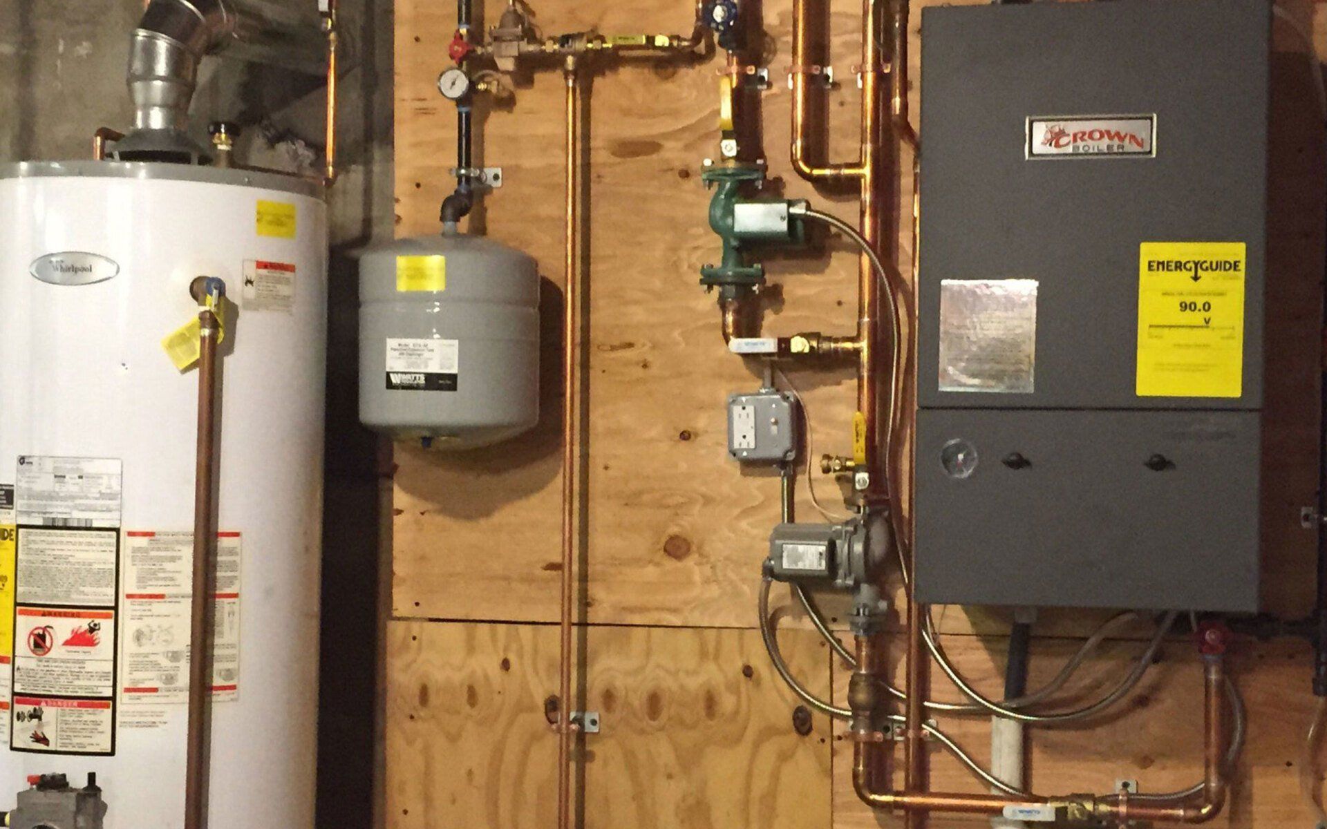 A water heater and a boiler are connected to a wall