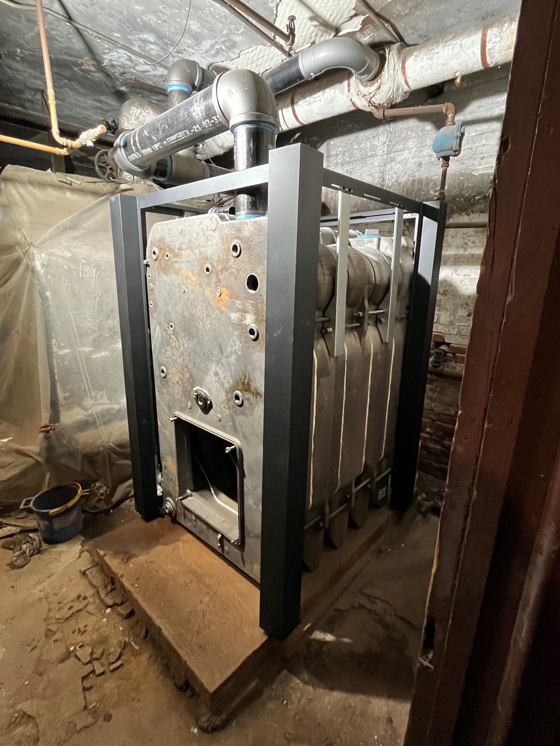 a large boiler is sitting on the floor in a basement