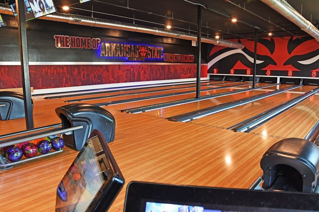 A bowling alley with a sign that says the home of bowling
