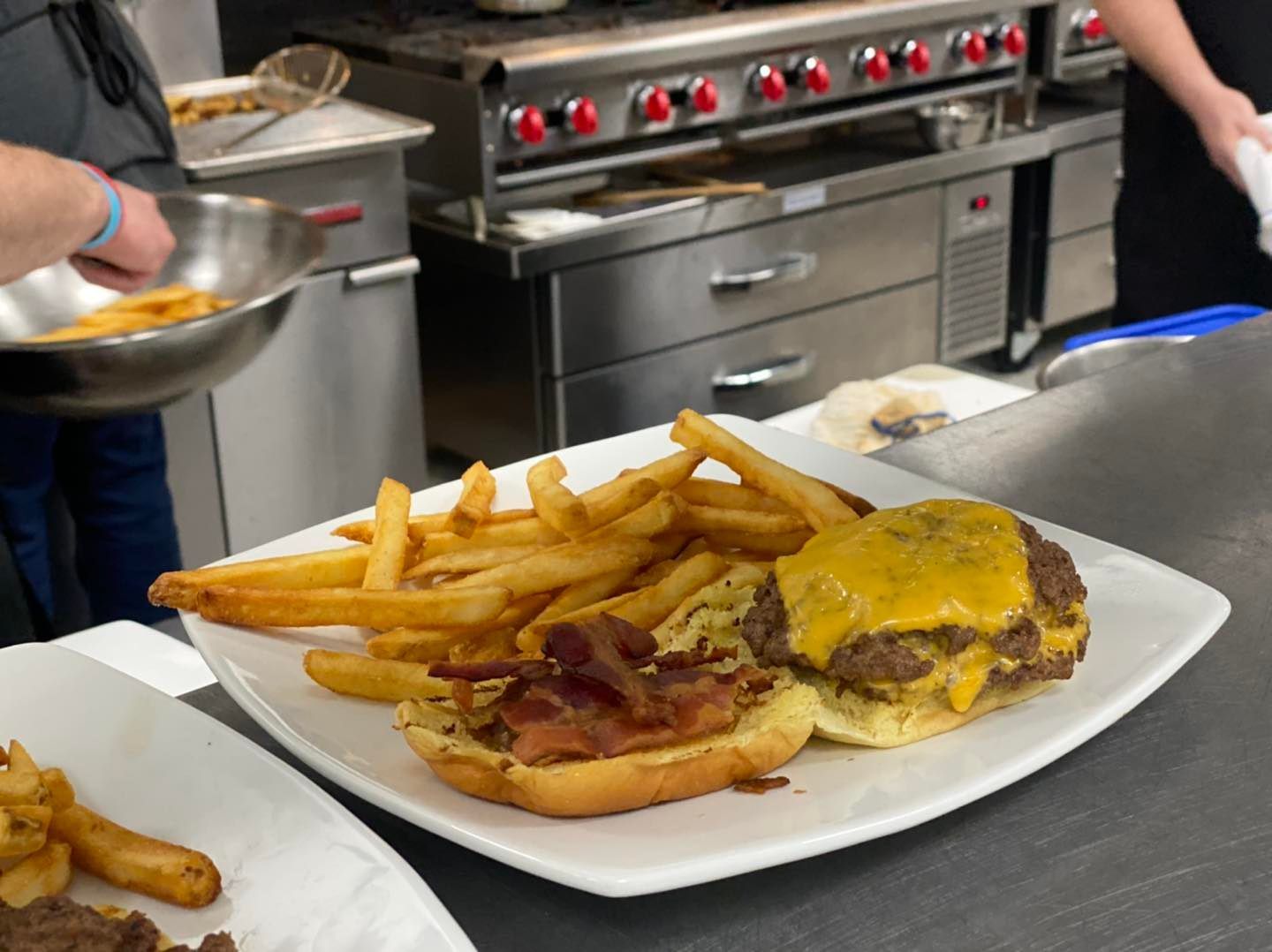 A white plate topped with a hamburger and french fries