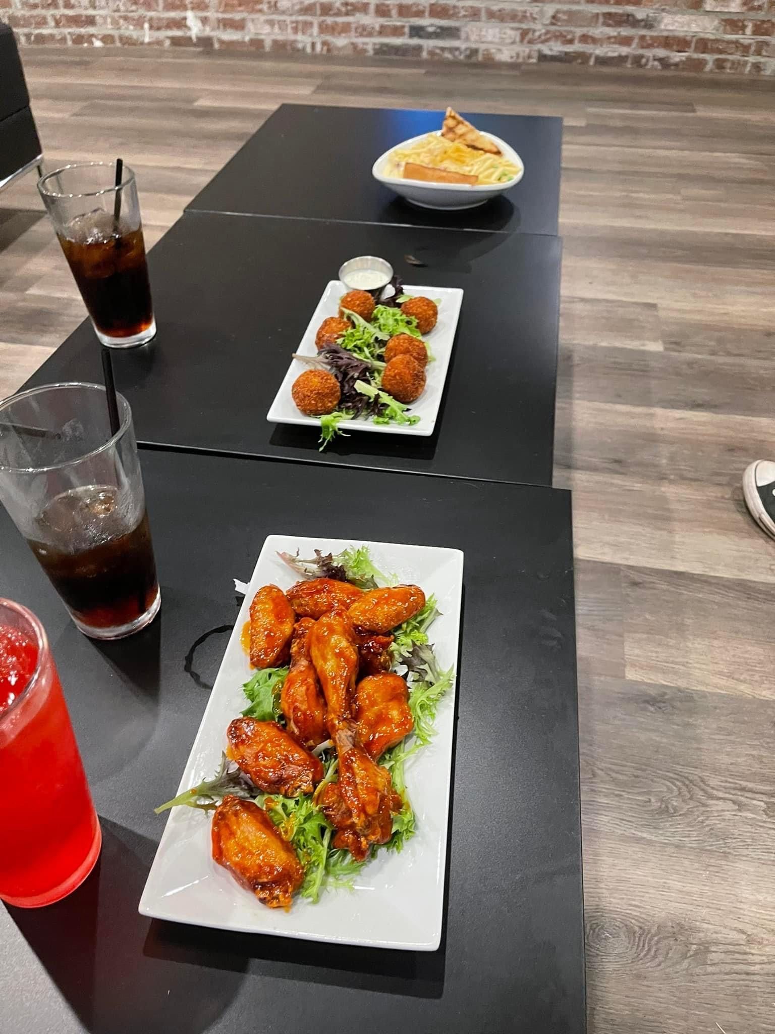 A table topped with plates of food and drinks.