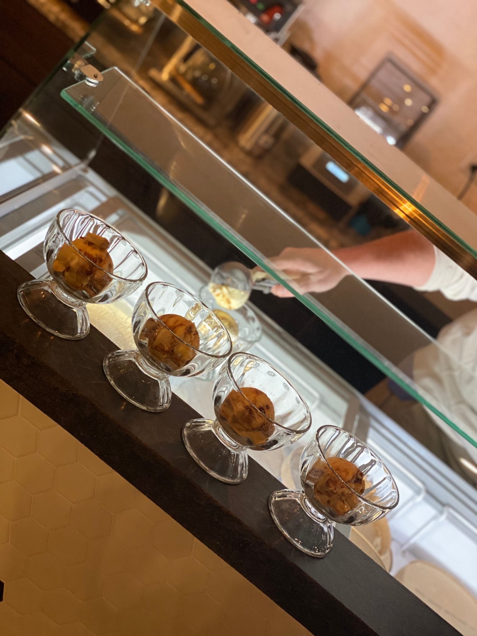 A glass display case filled with a variety of desserts
