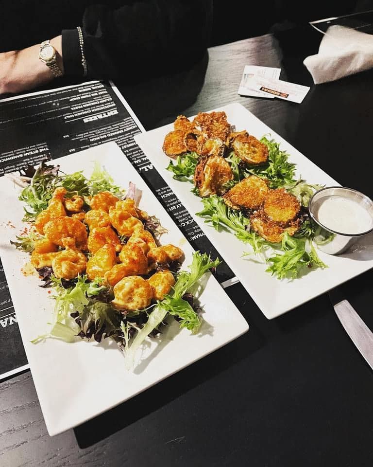 Two plates of food are sitting on a table.