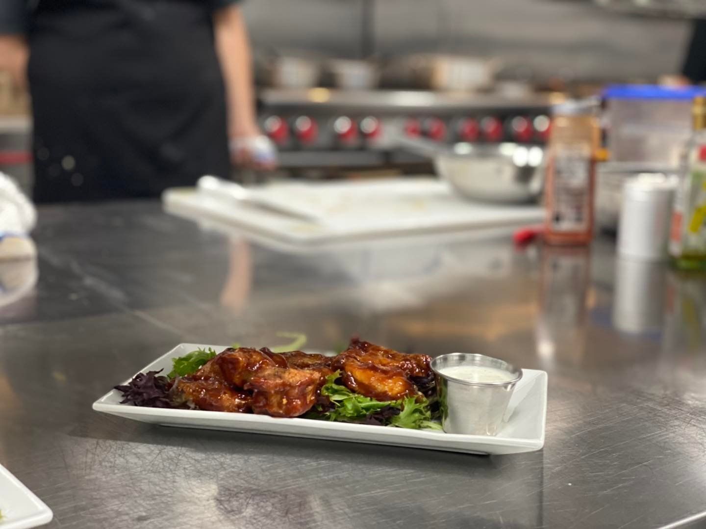 A plate of food is sitting on a counter in a kitchen.