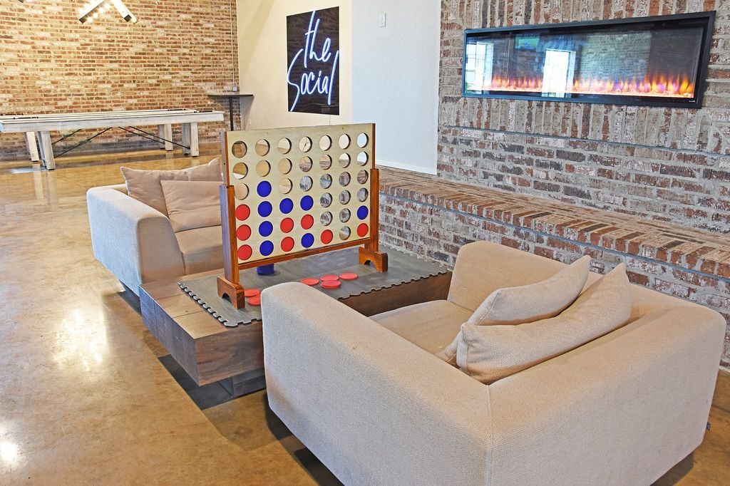 A living room with a couch and chairs and a fireplace