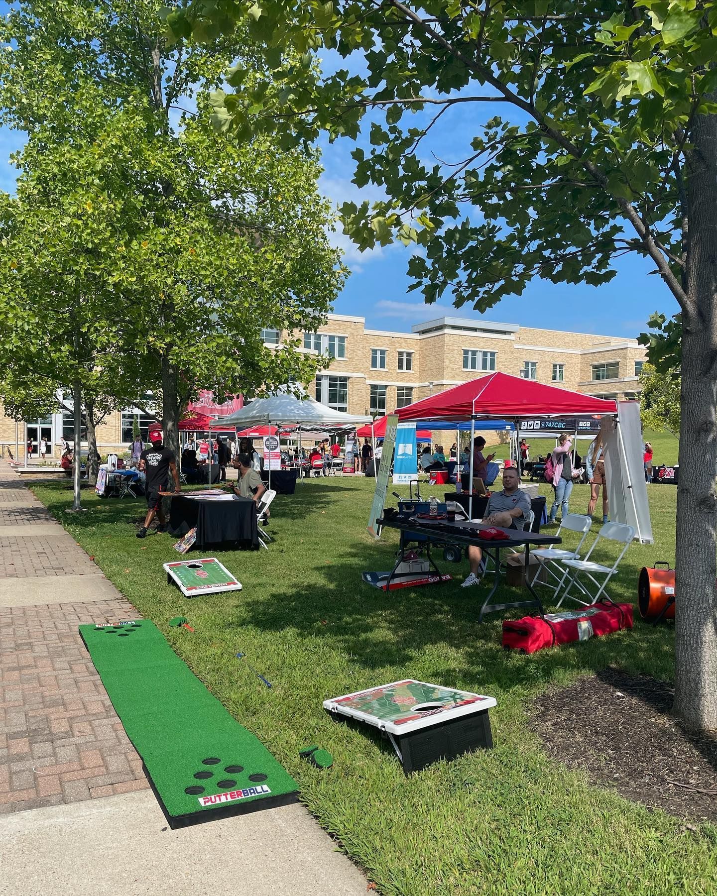 A group of people are playing games in a park.