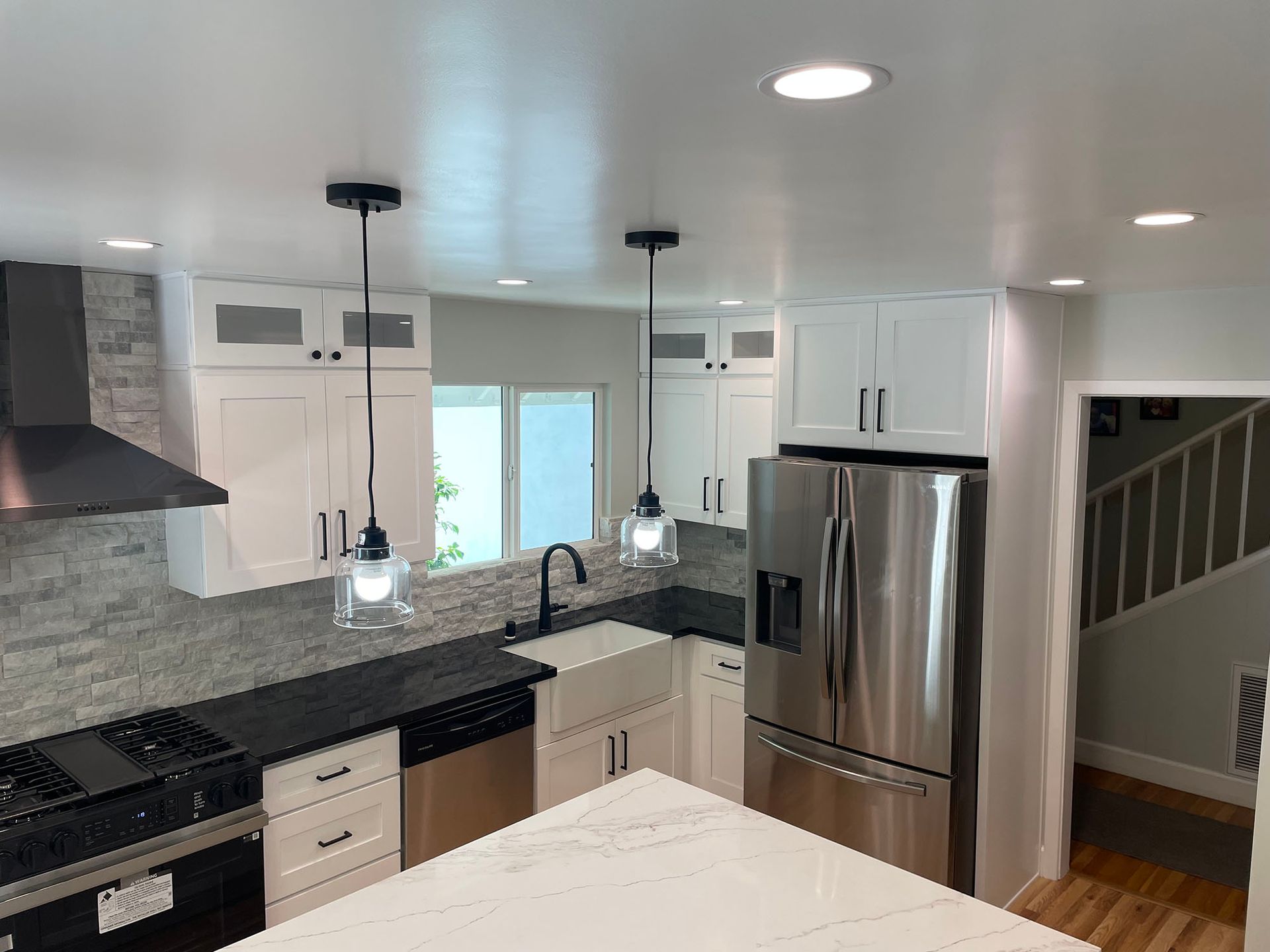 A kitchen with stainless steel appliances and white cabinets