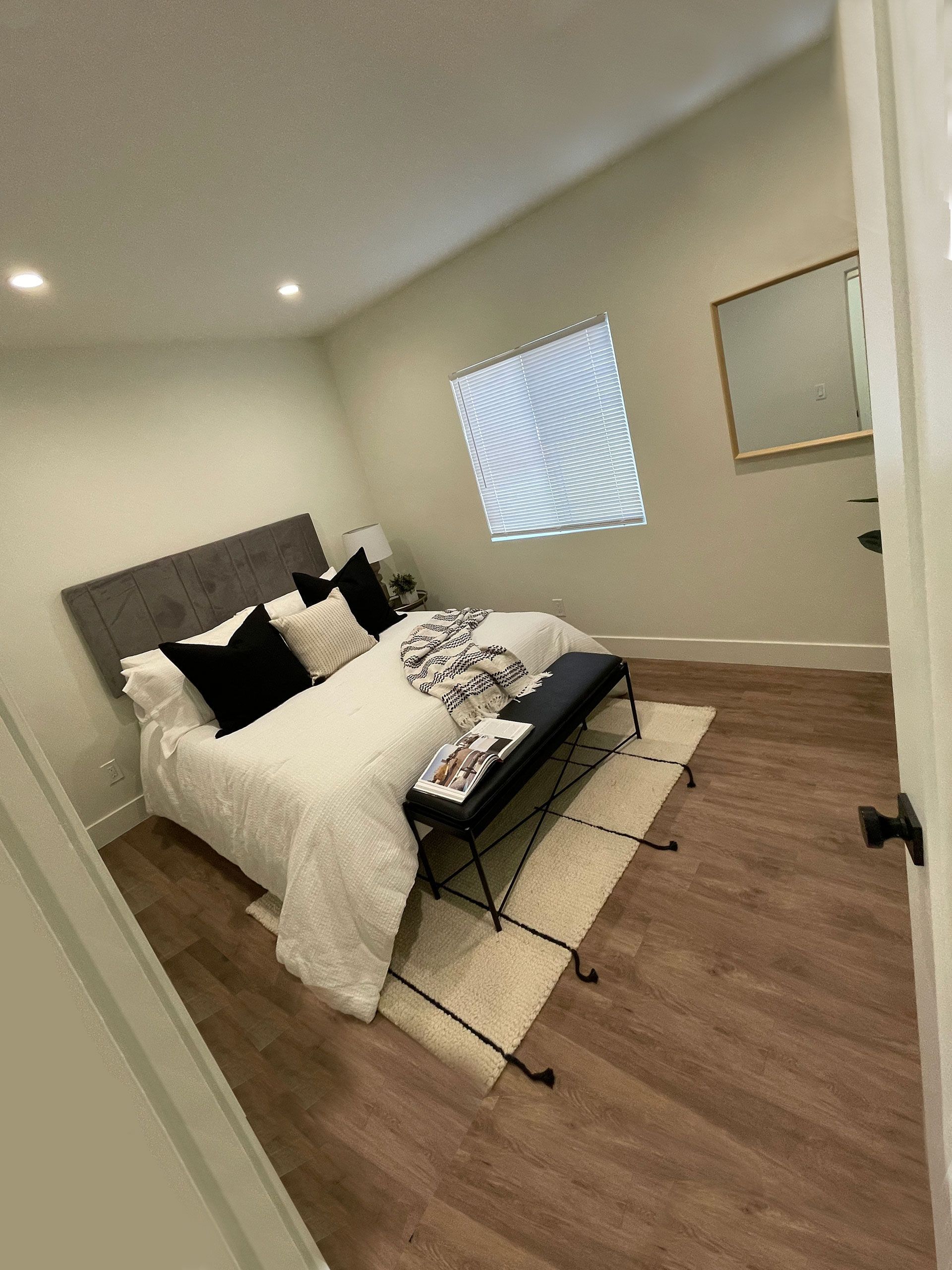 A bedroom with a bed and a window