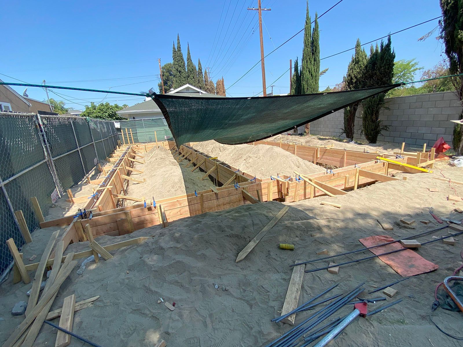 A construction site with a fence and a tarp covering it