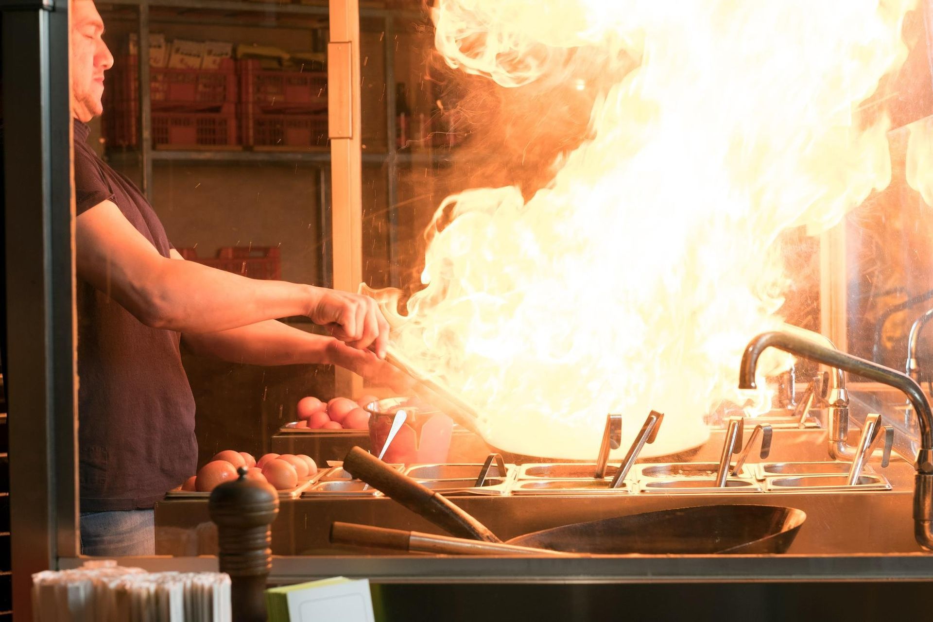 chef at restaurant with fire on stove learning about restaurant fire prevention