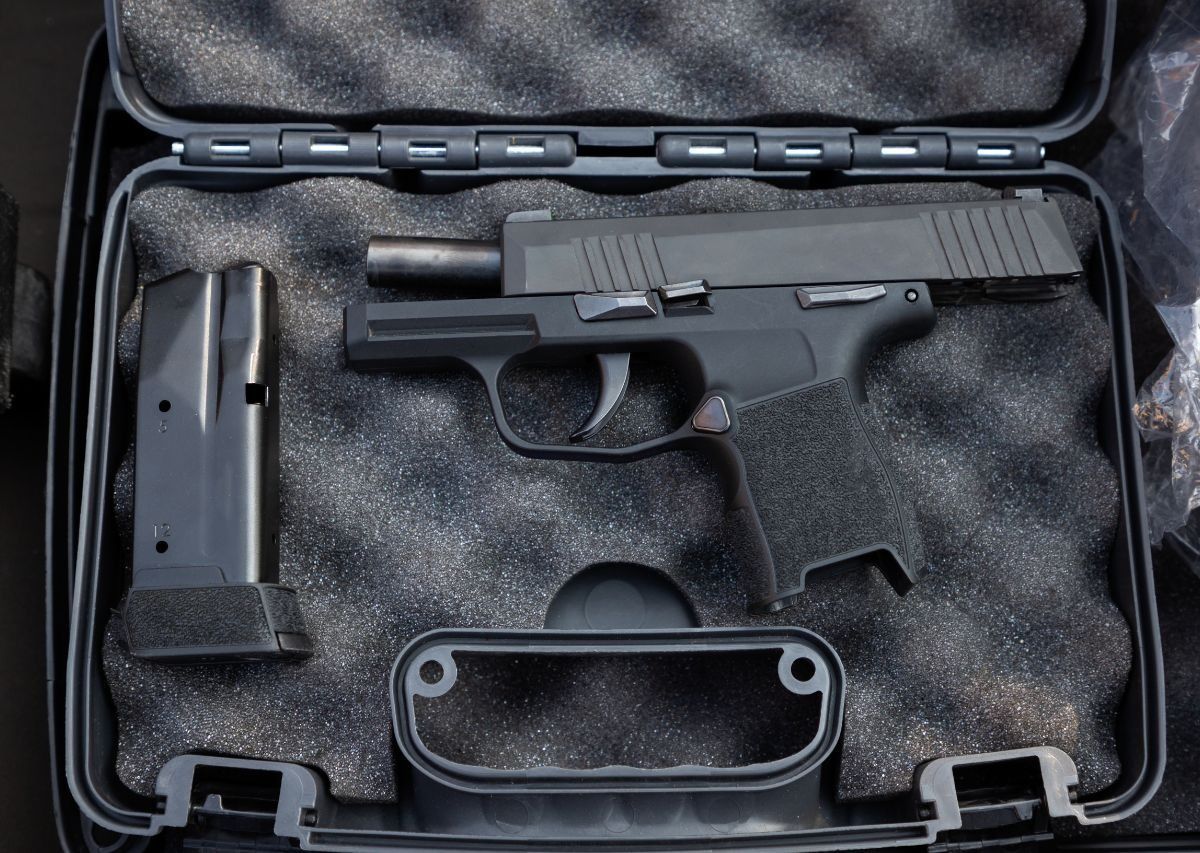 Handgun and two magazines in a foam-lined hard case
