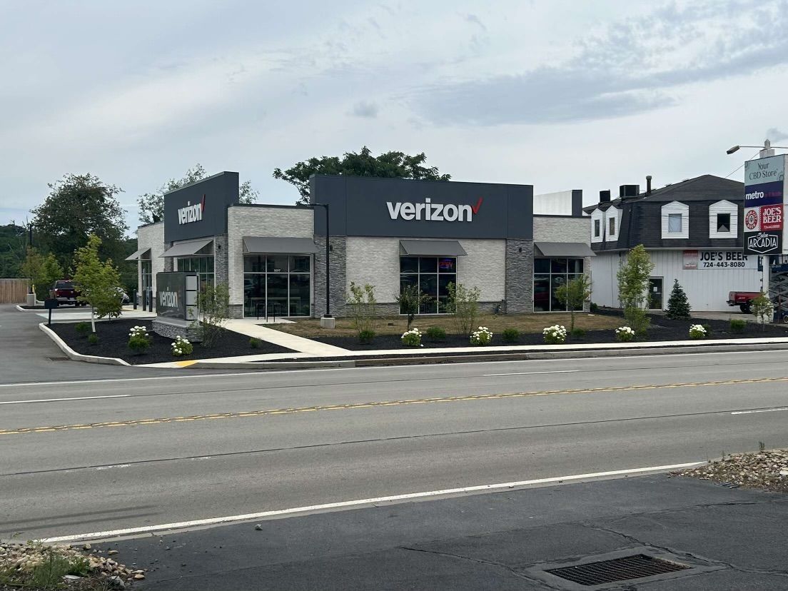 A verizon store is located on the corner of a street.