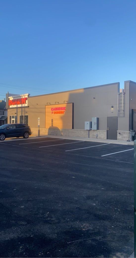 A large building with a parking lot in front of it