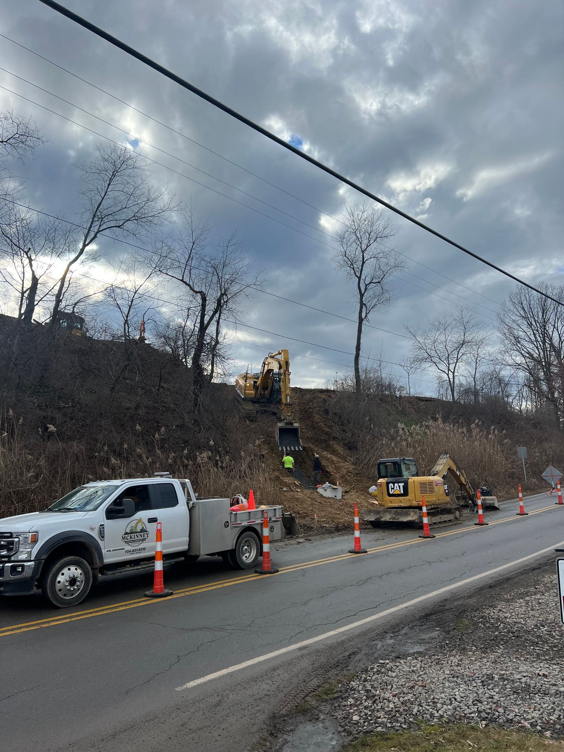 A white truck is parked on the side of a road.
