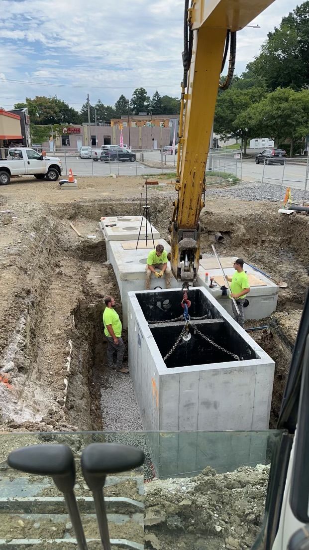 A group of construction workers are working on a large concrete structure.