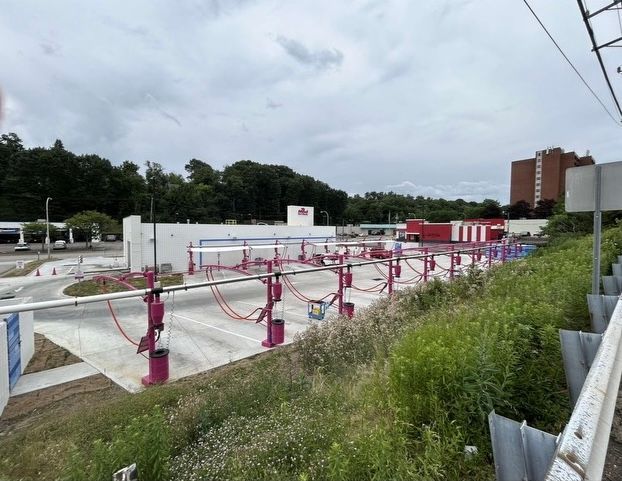 A car wash is being built in the middle of a field.