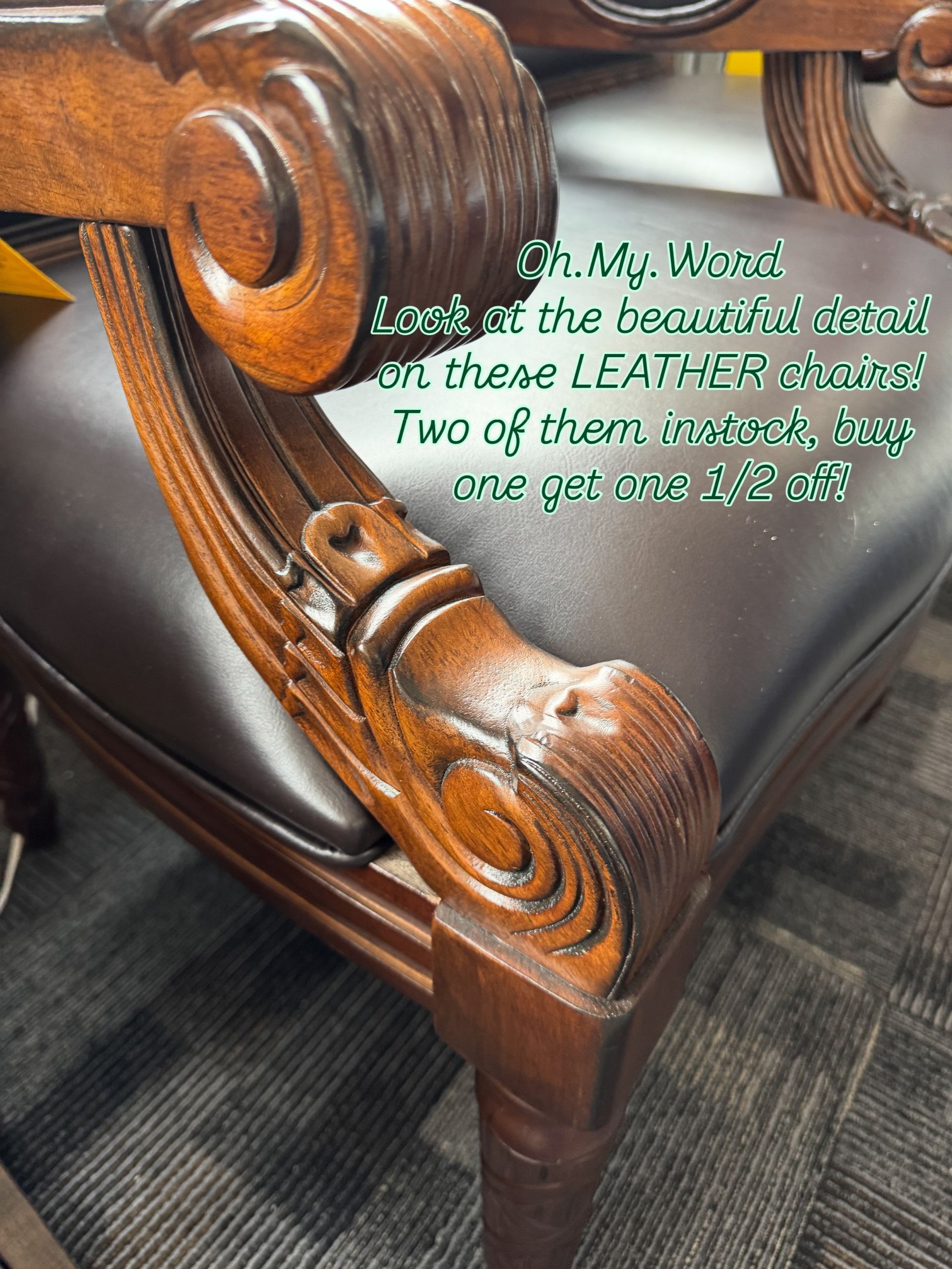 Close-up of a brown leather chair with ornate wooden armrest detailing.