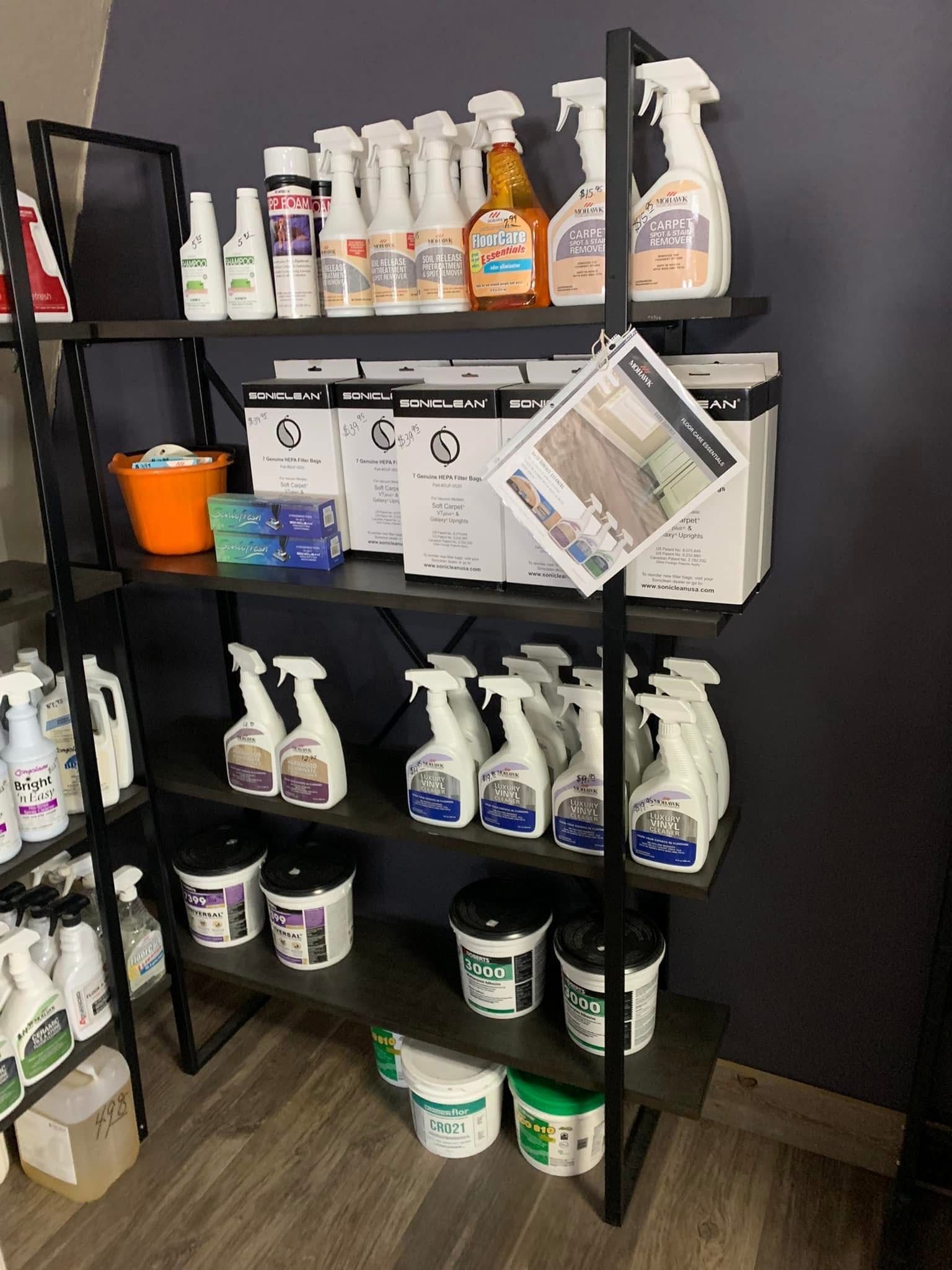 Shelves stocked with cleaning products and supplies in a store setting.