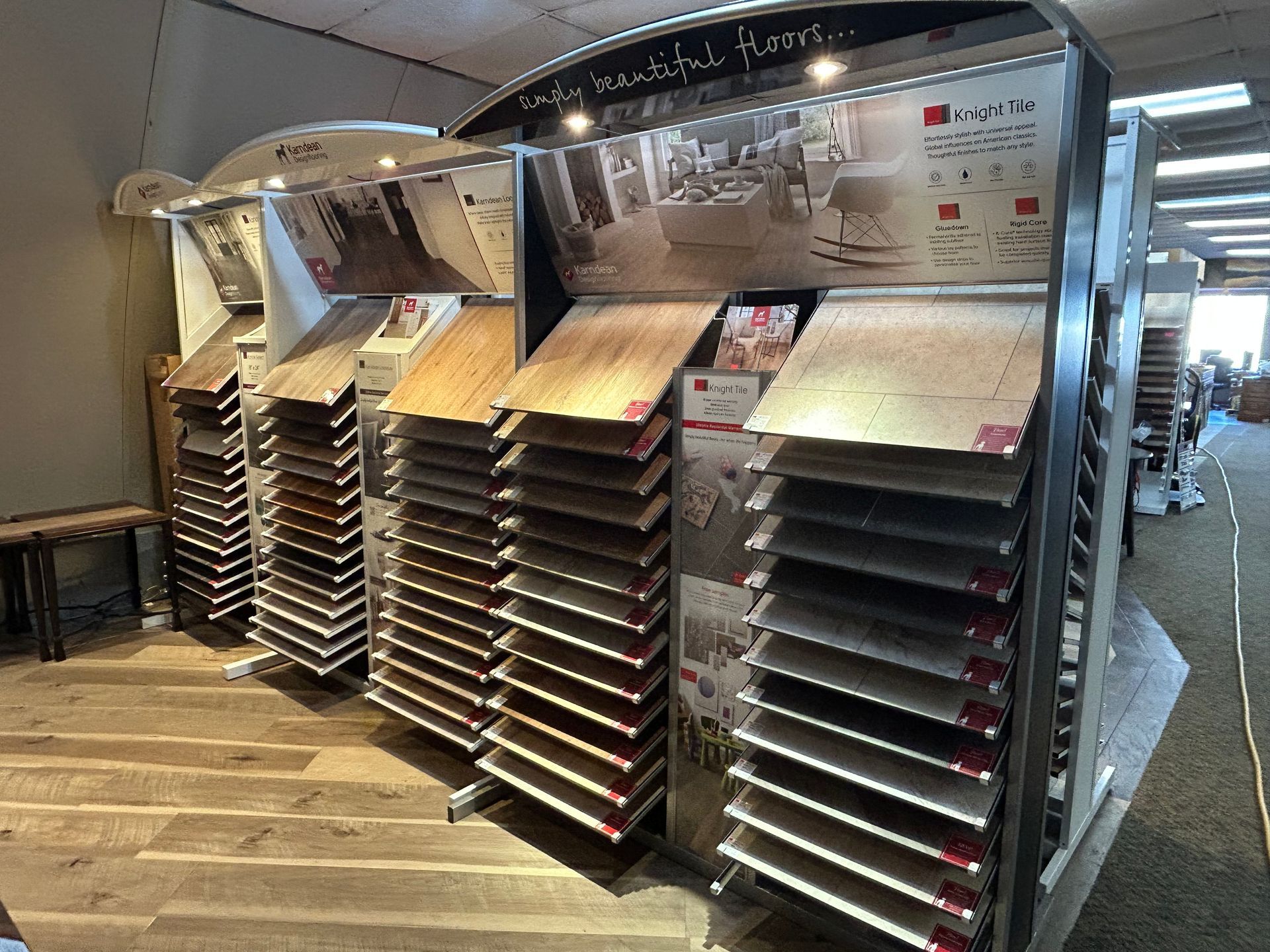 Flooring display featuring various wood samples in a store setting.