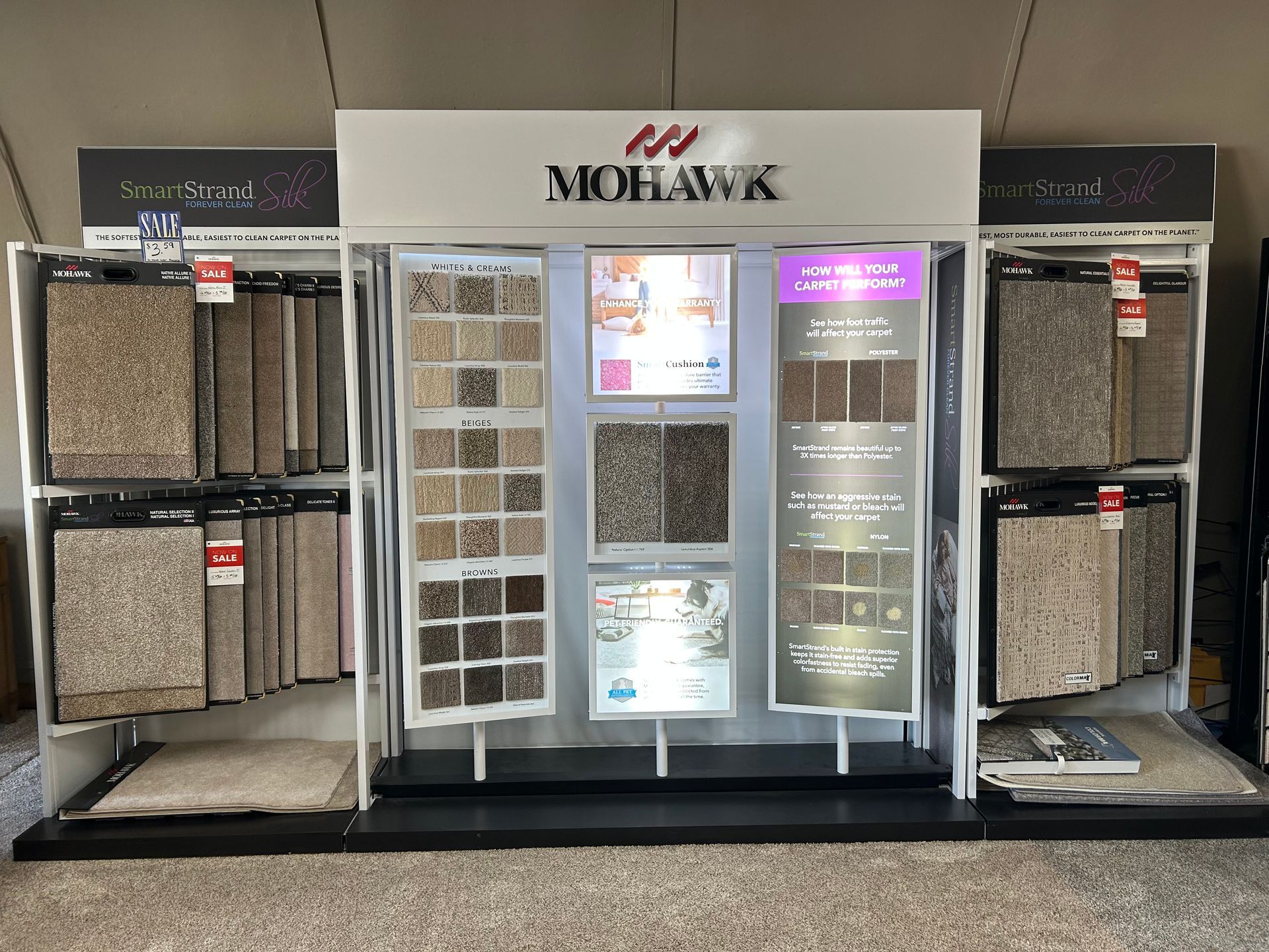 Mohawk carpet display with various sample swatches in a store setting.