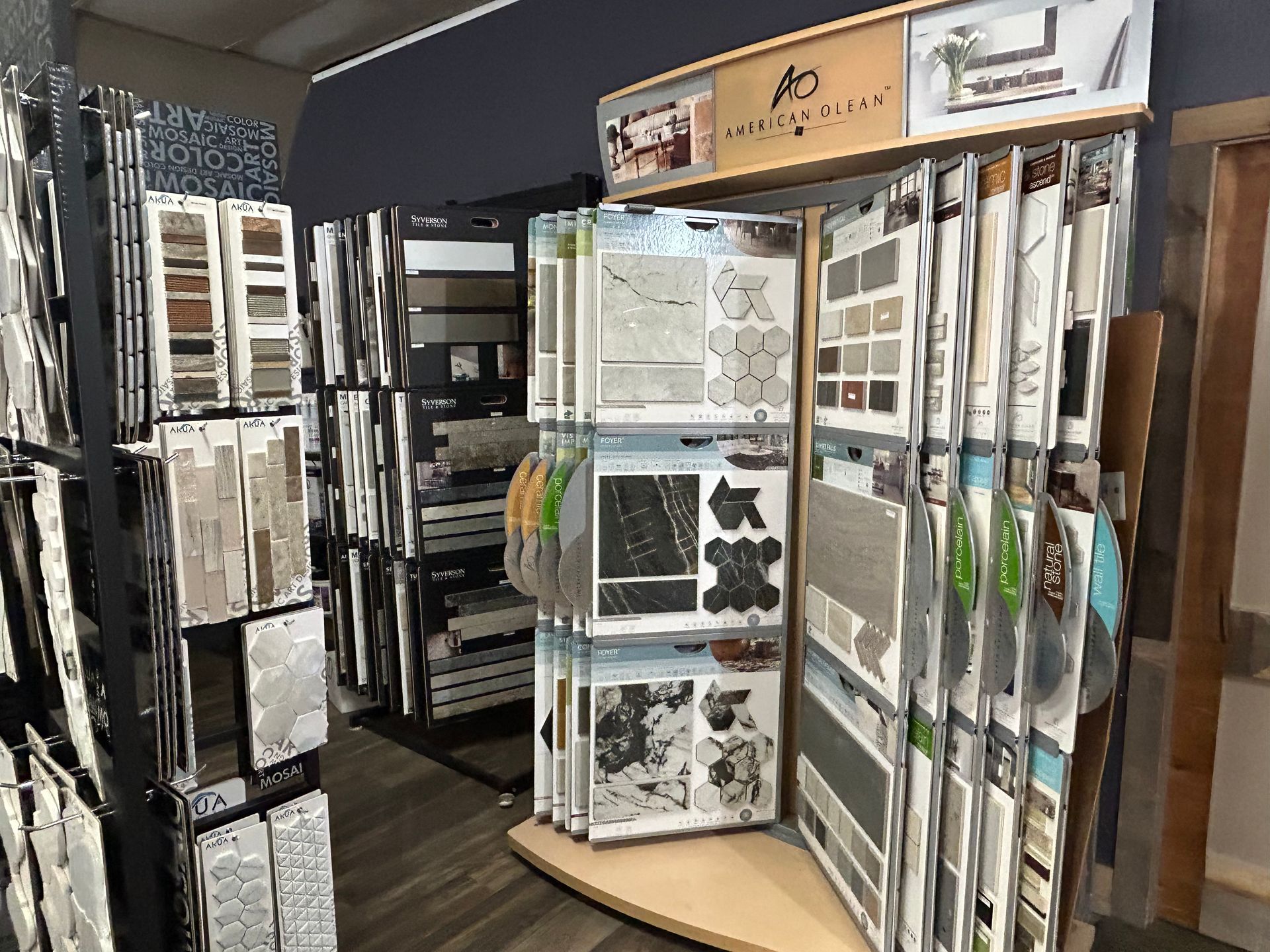 Tile samples on display in a store, arranged on racks.