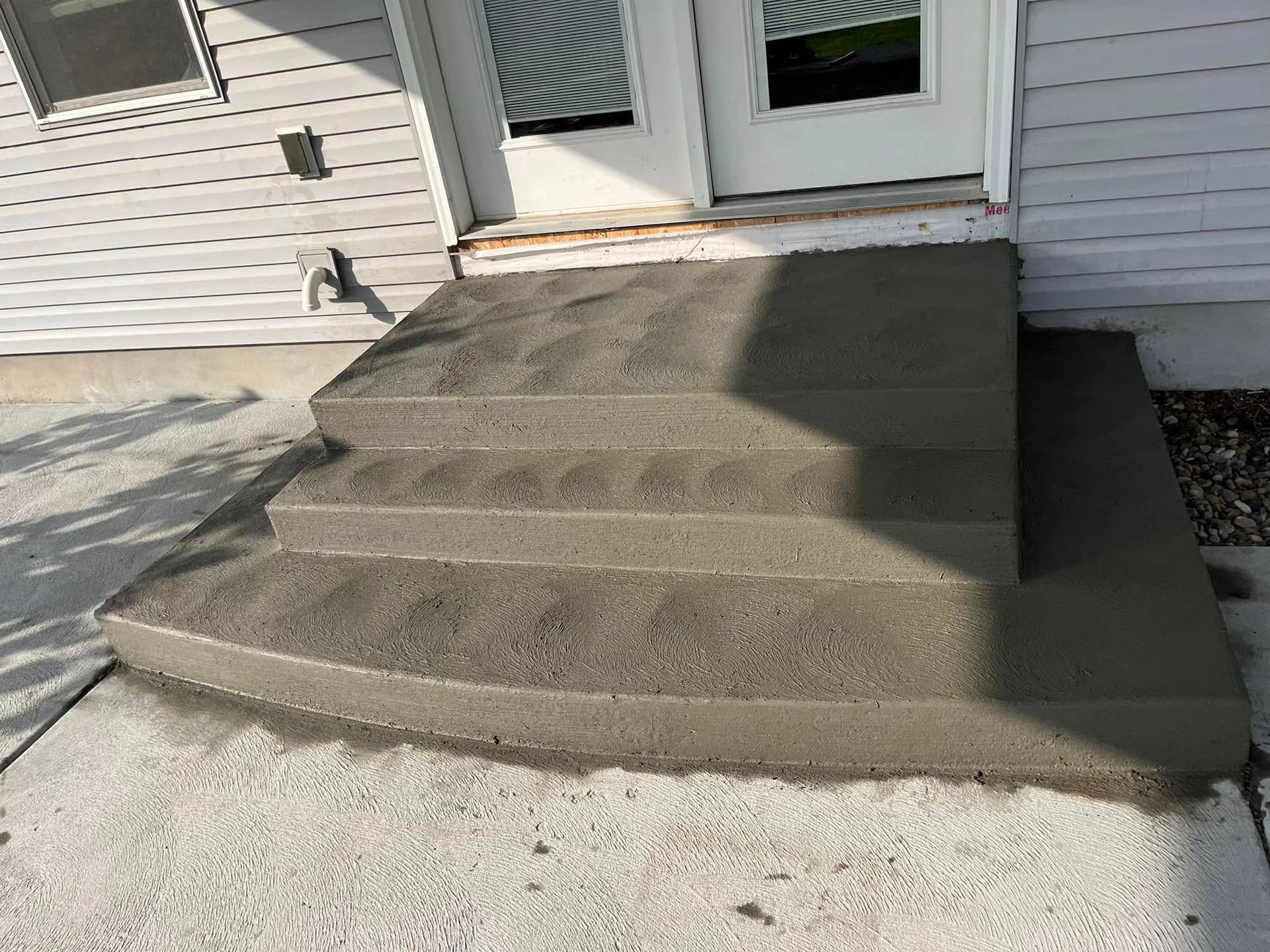 A set of concrete steps leading up to a house