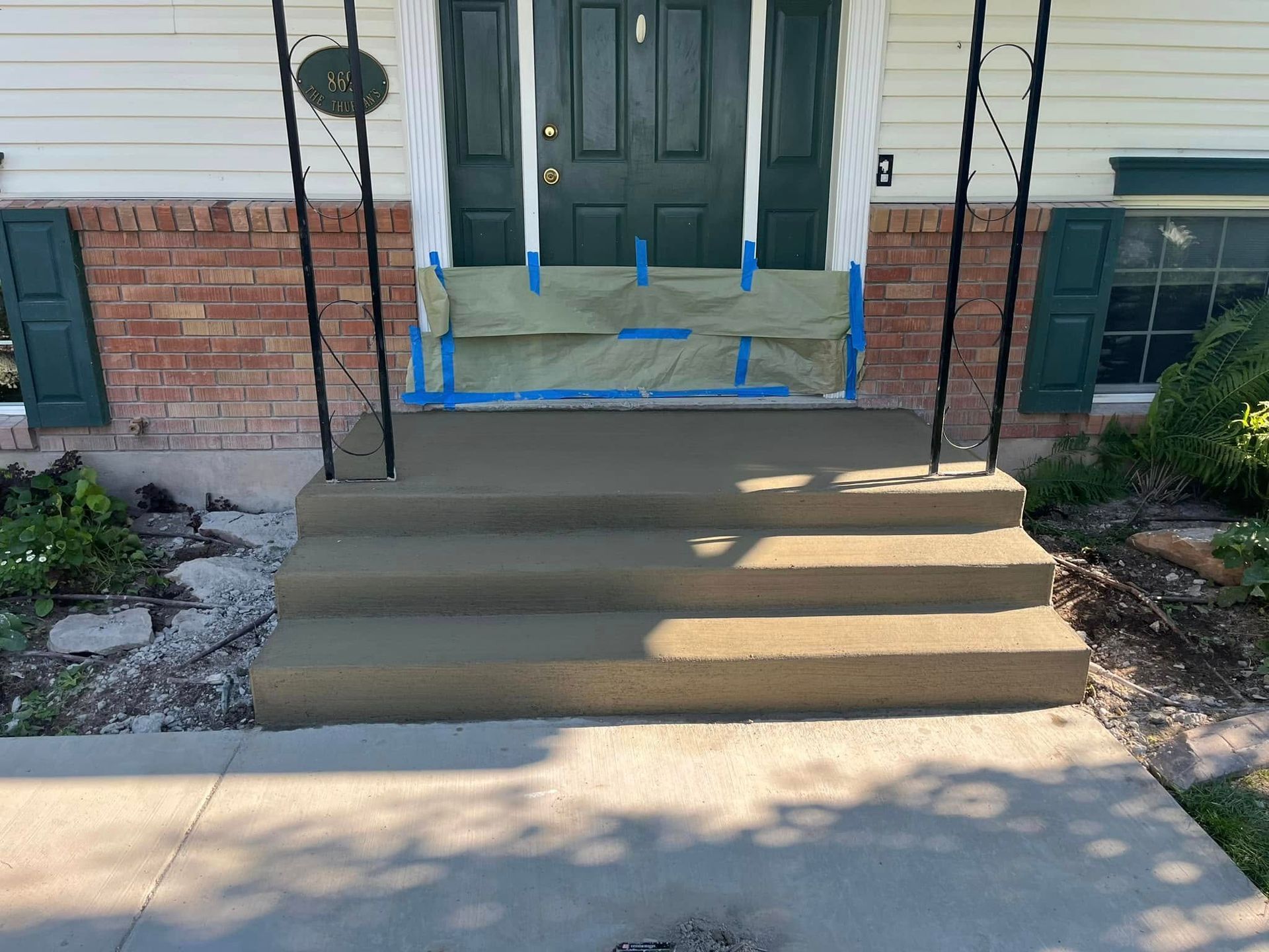 A house with concrete steps leading up to the front door
