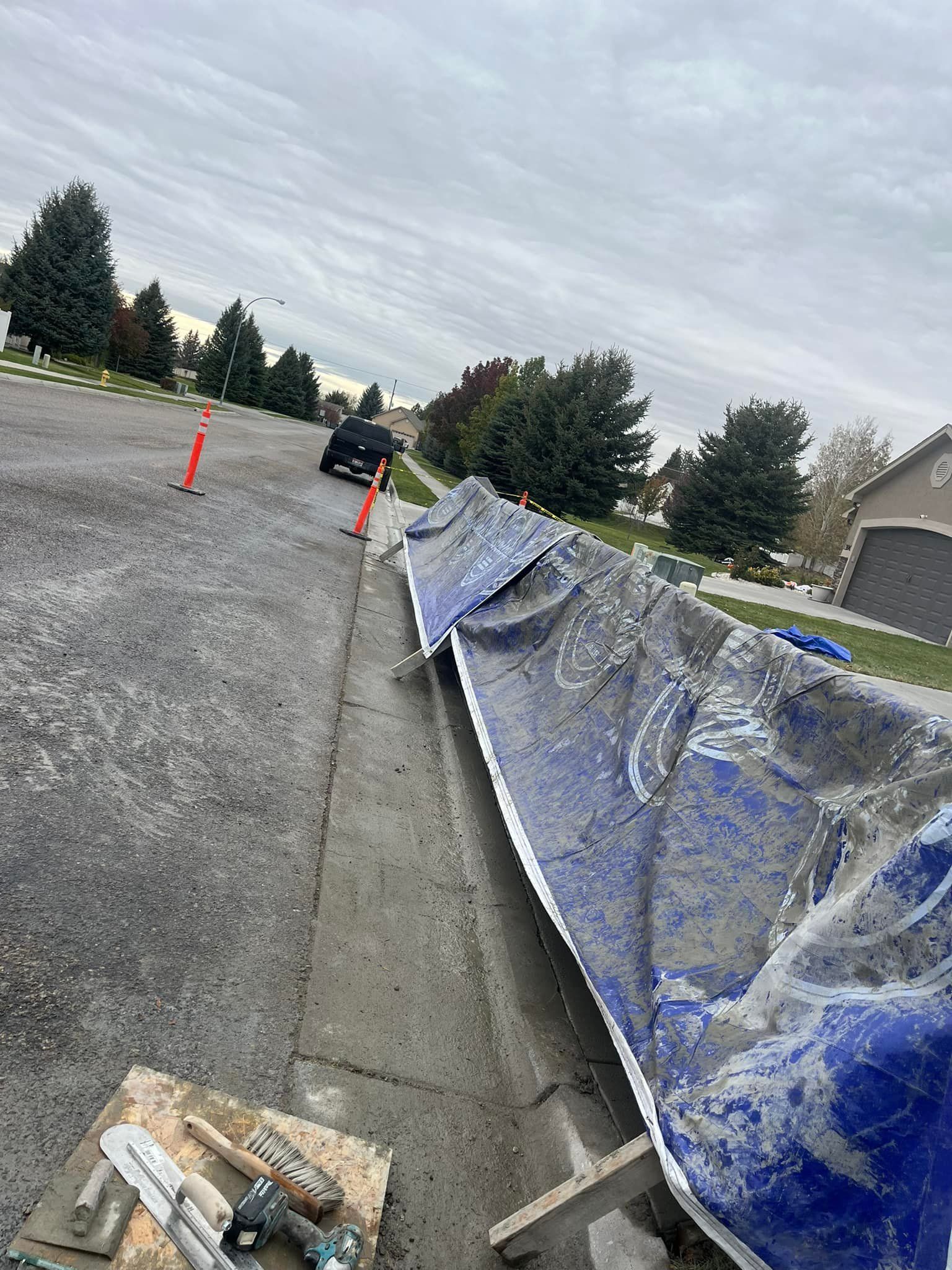 A blue tarp is sitting on the side of a road