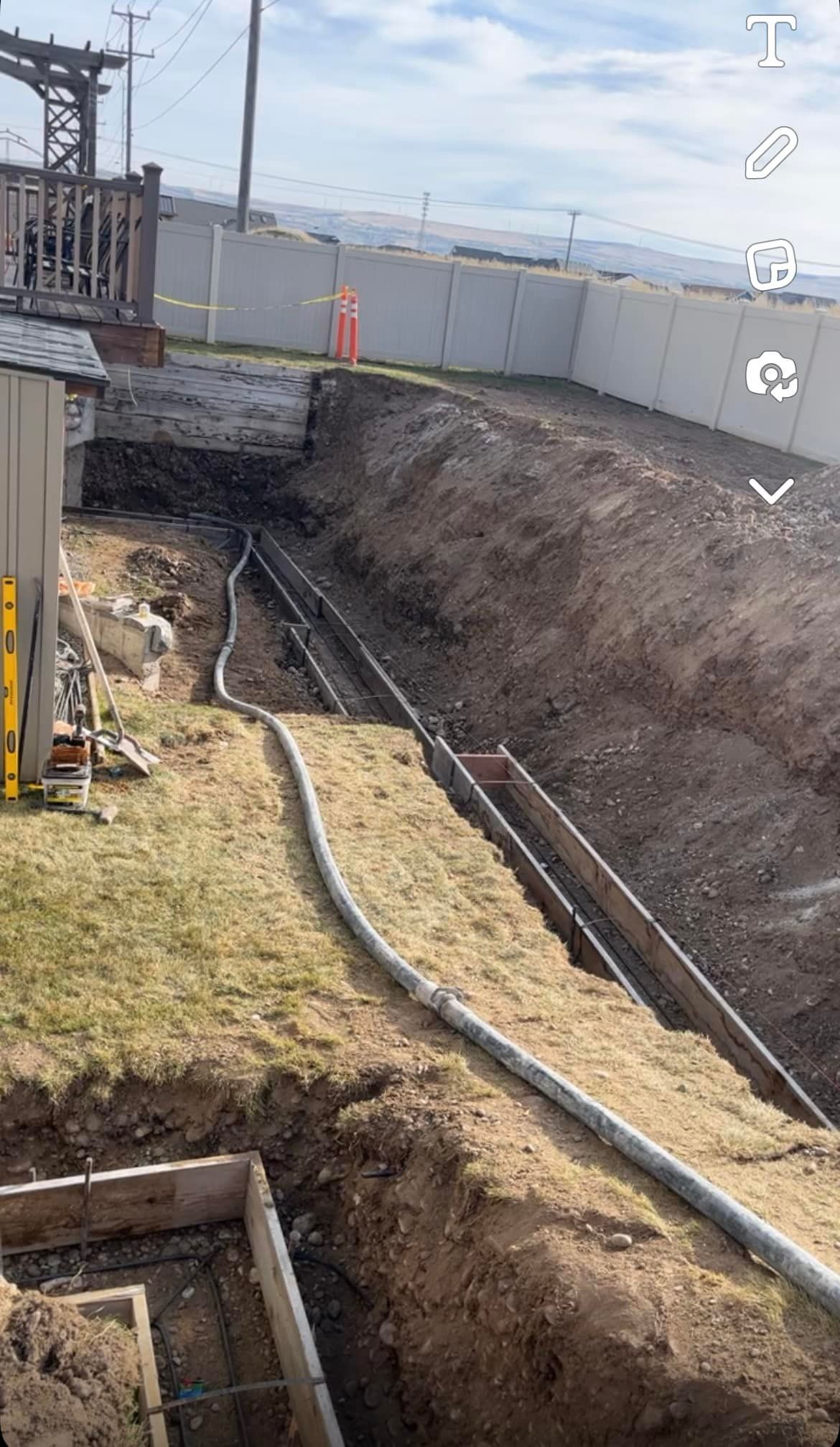 A large hole in the ground with a hose coming out of it