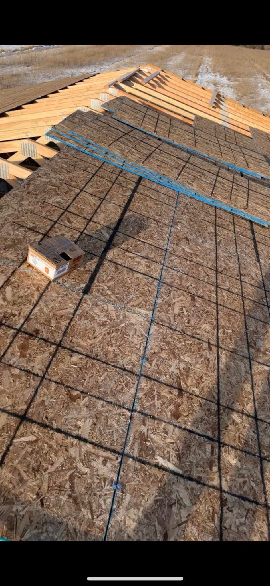 A picture of a roof being built with plywood