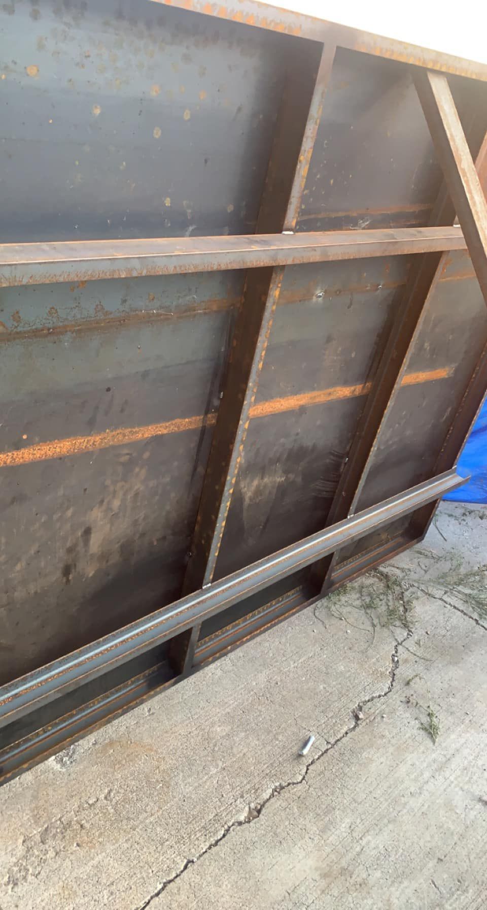 A metal shelf is sitting on top of a concrete floor