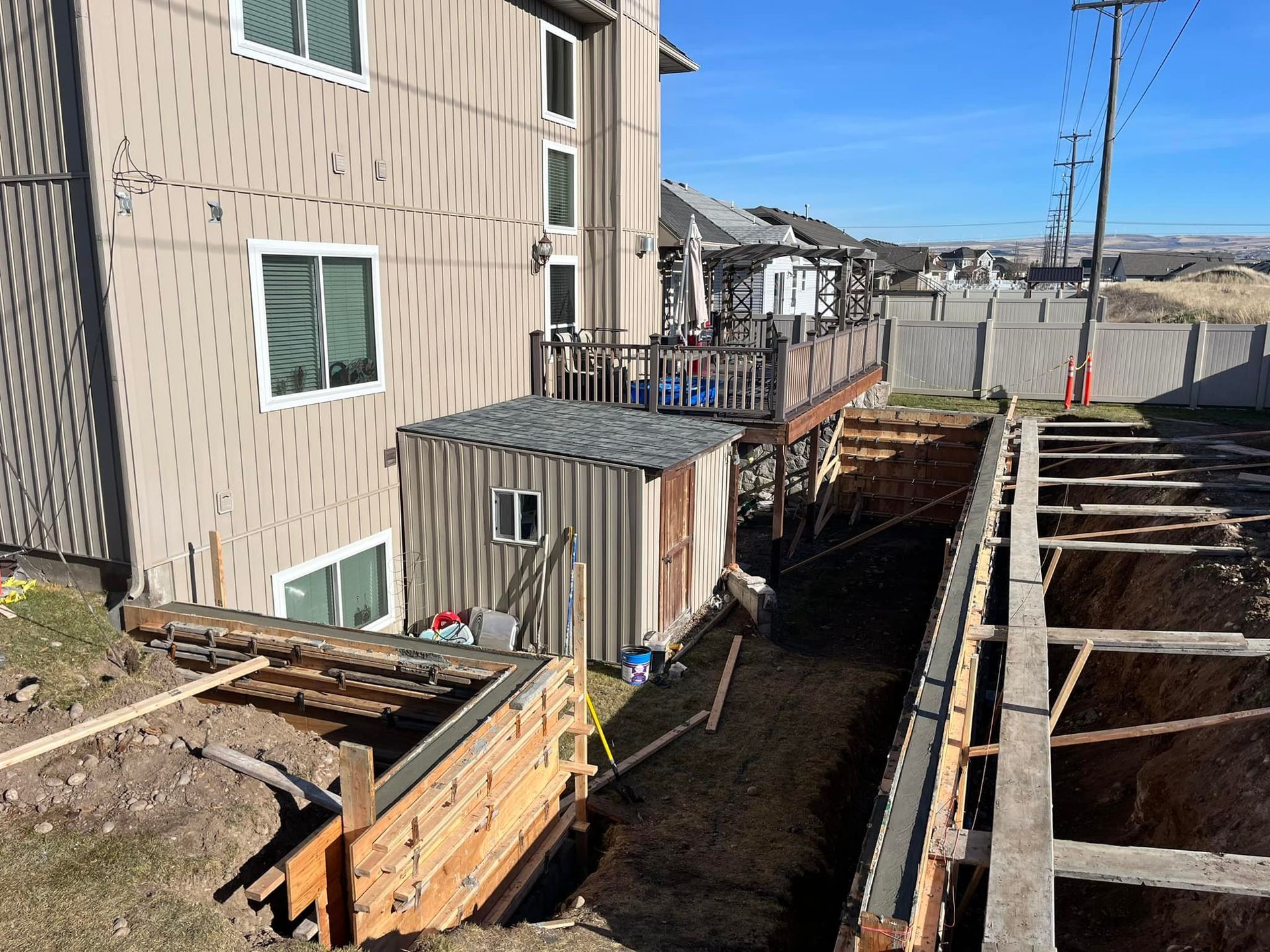 A house is being remodeled with a concrete wall and a deck