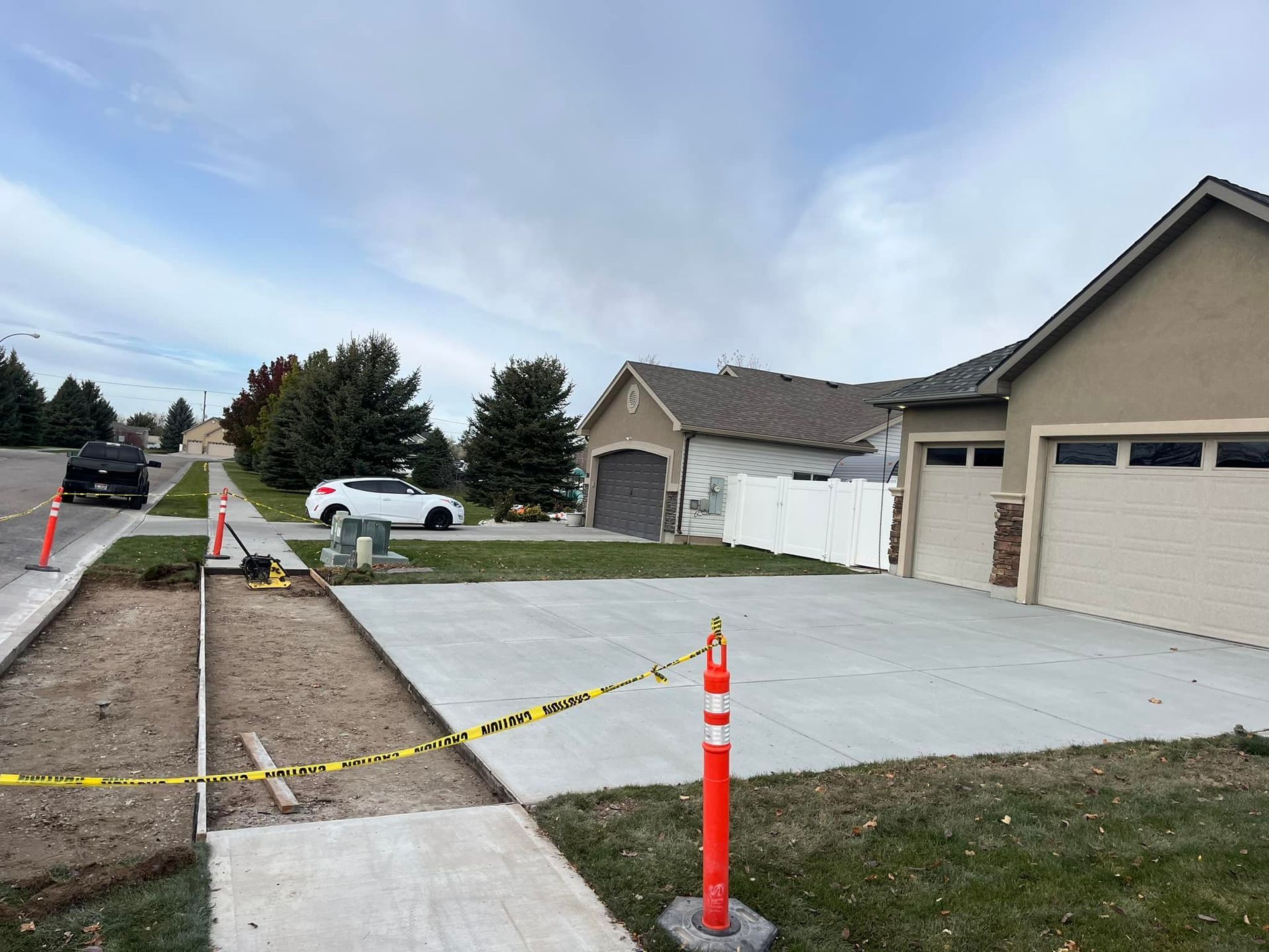 A concrete driveway is being built in front of a house