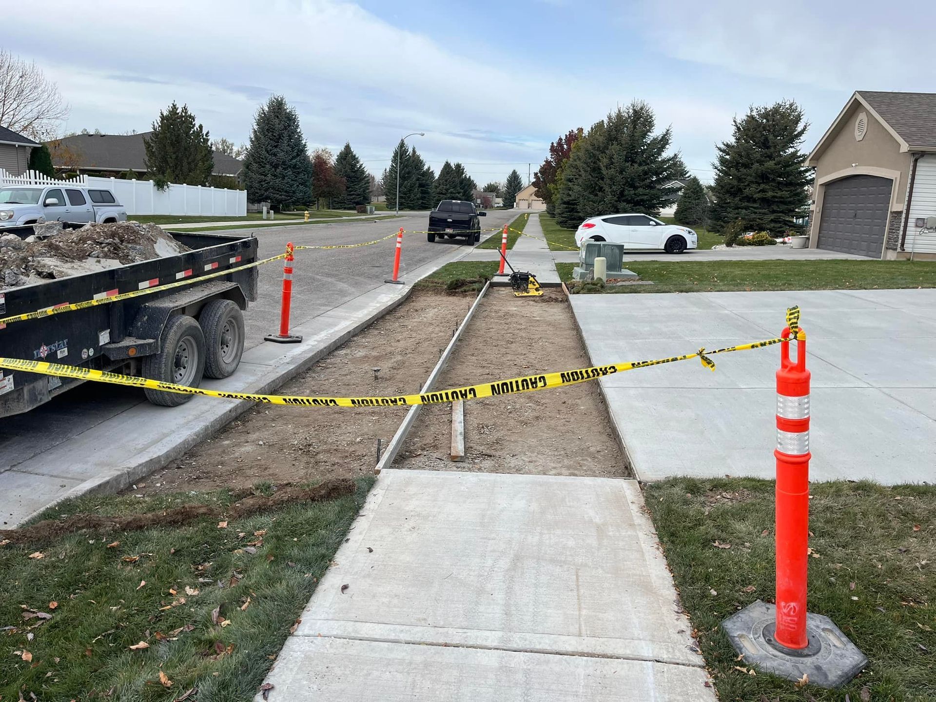 A concrete sidewalk is being built in a residential neighborhood