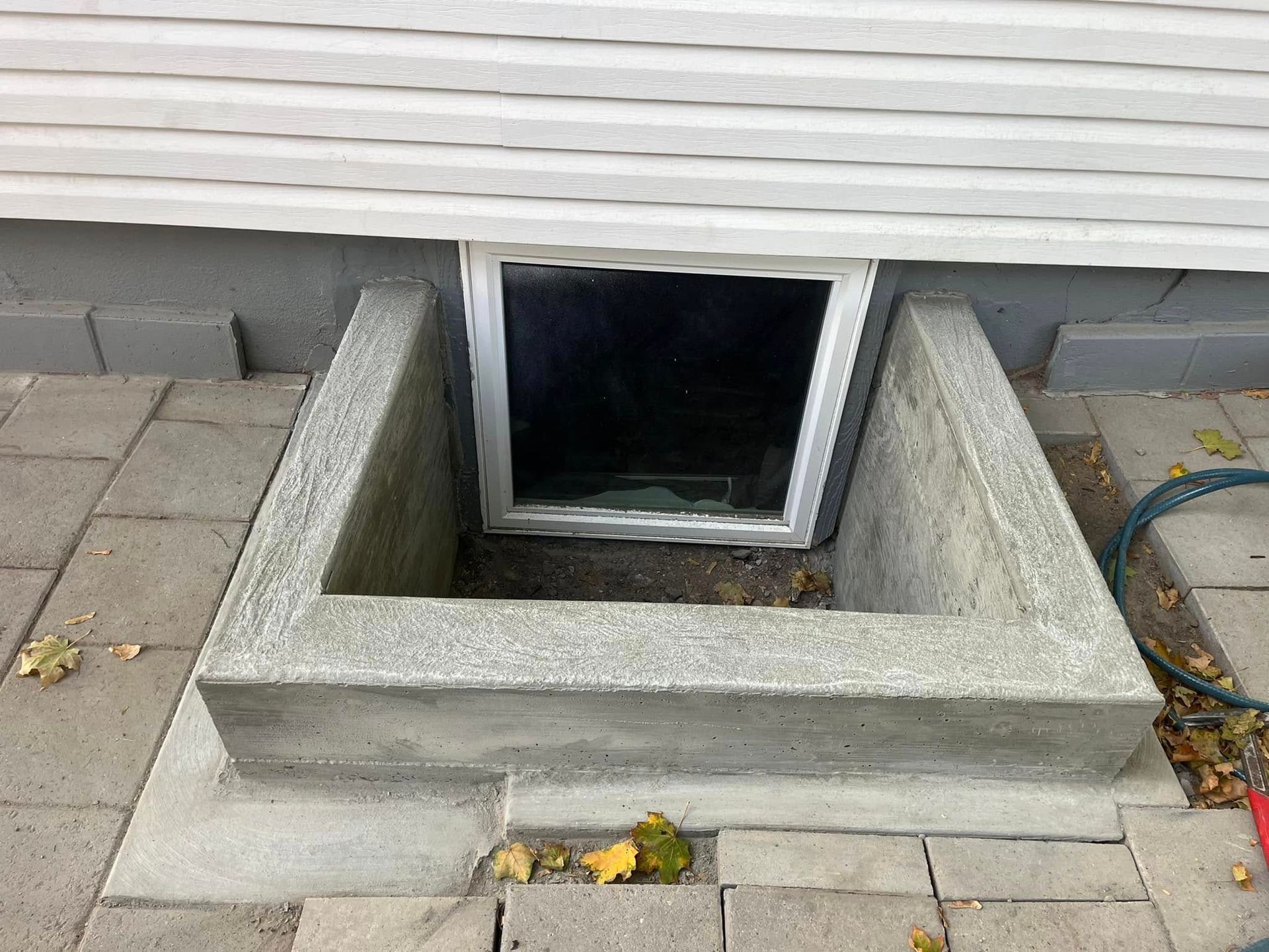 There is a window in the basement of a house